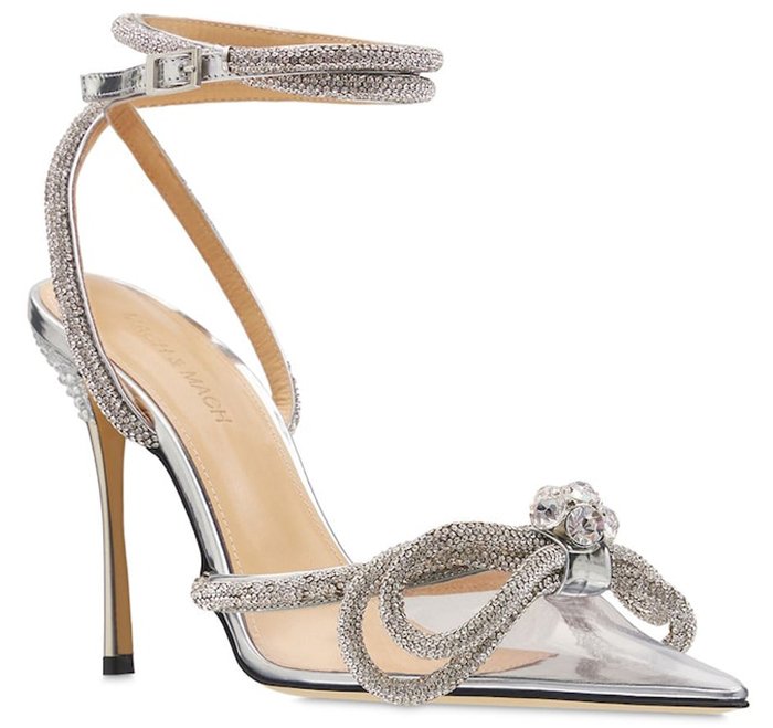 The Mach & Mach pumps boast silver straps with microcrystal embellishments and a double bow design on the PVC pointed toes