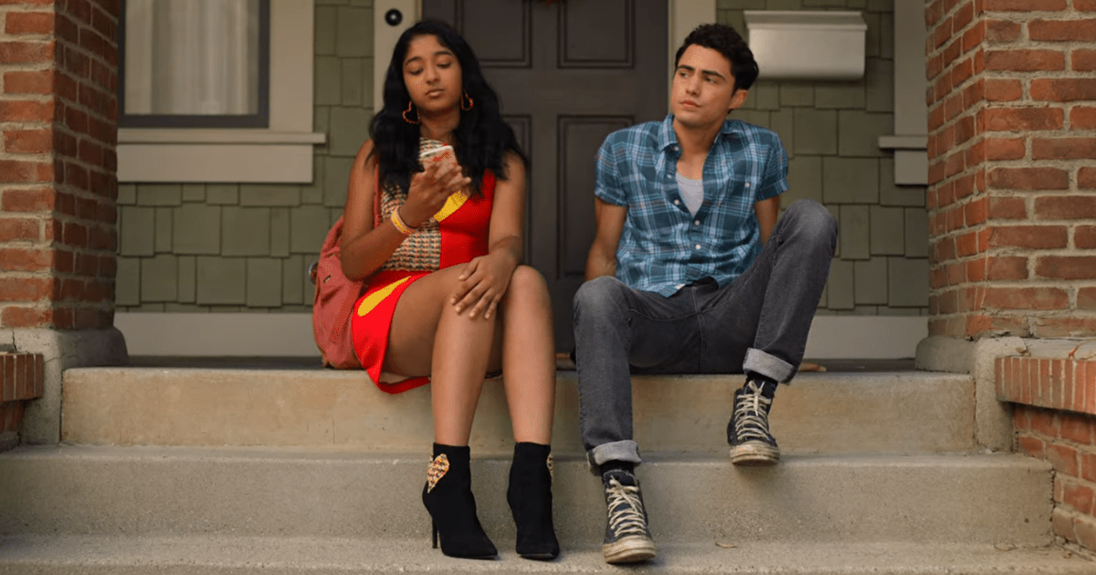 Maitreyi Ramakrishnan, as Devi, and Darren Barnet, as Paxton, share a scene on the steps in Never Have I Ever, showcasing their on-screen chemistry despite their real-life 11-year age difference