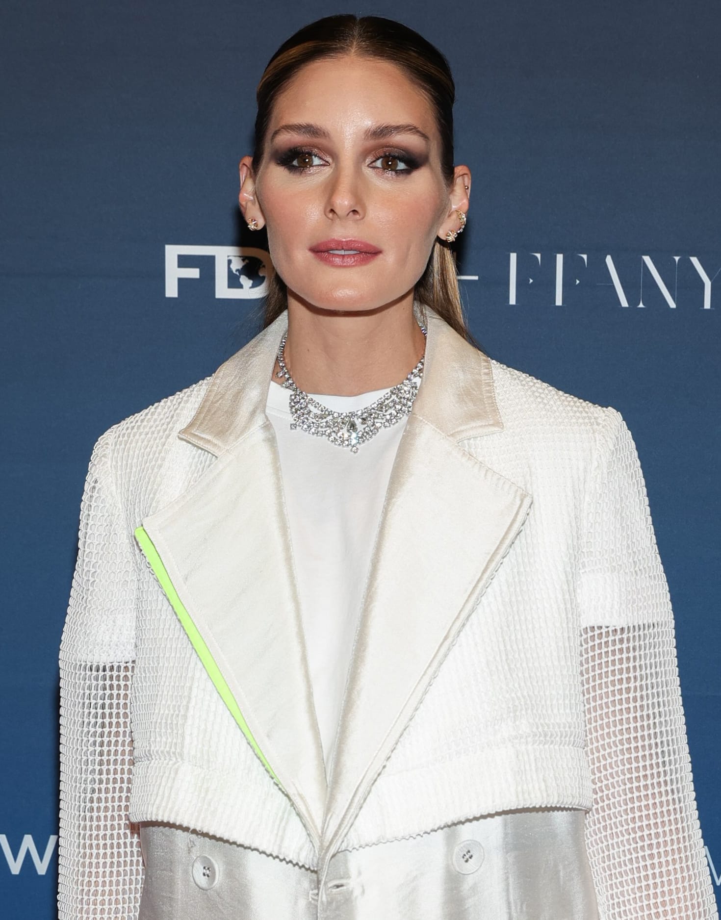 Olivia Palermo wears her tresses in a half-up, half-down style with black and pink smokey eyeshadow