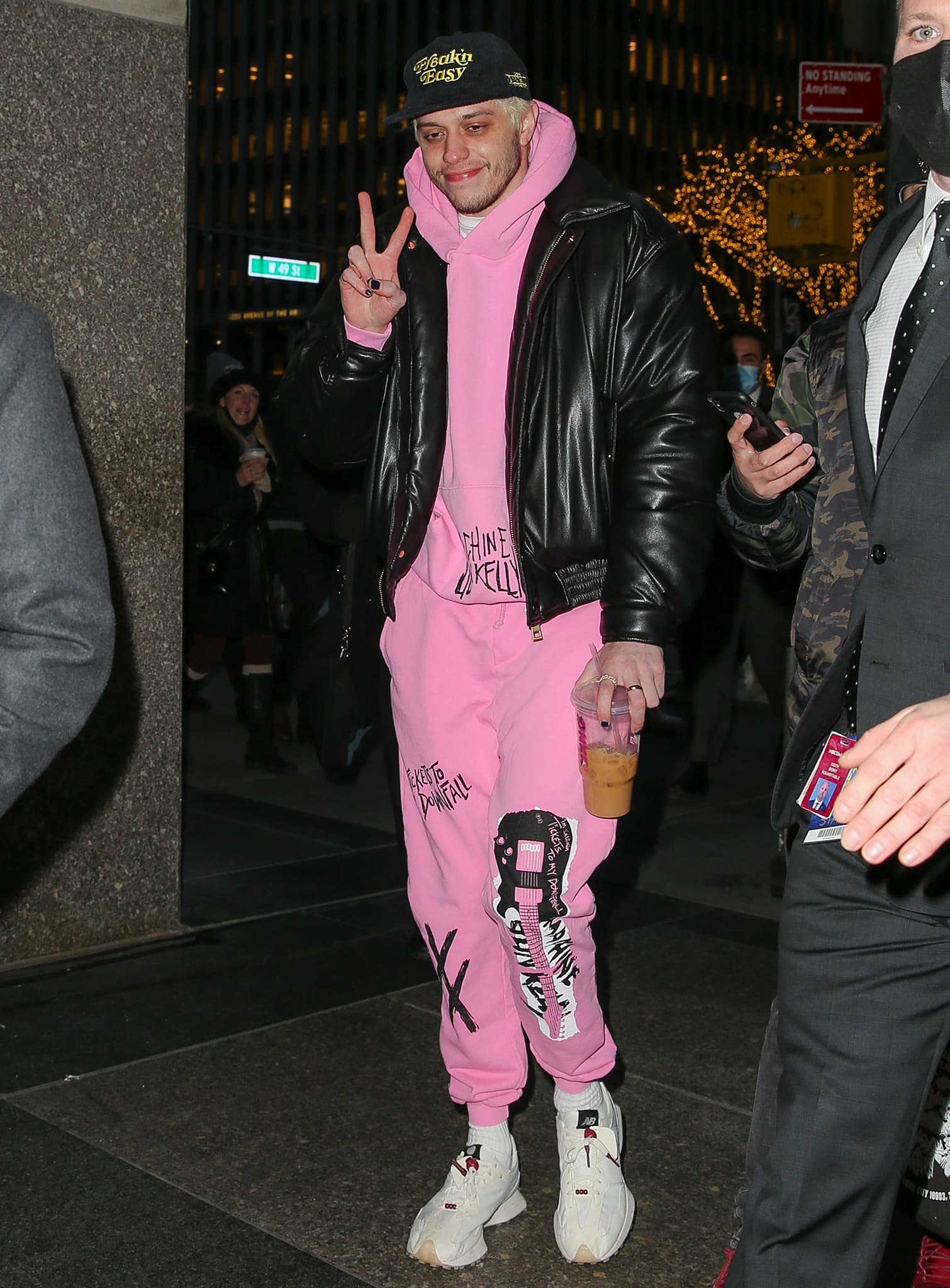 Pete Davidson wears a pink sweatsuit from Machine Gun Kelly's Tickets to My Downfall merch