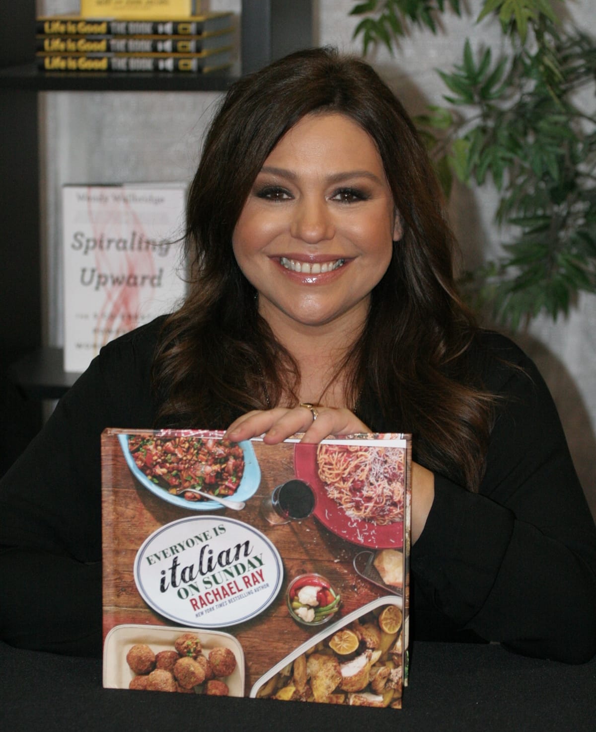 Wealthy celebrity chef Rachael Ray poses with her book, 'Everyone is Italian on Sunday' during Pennsylvania Conference For Women