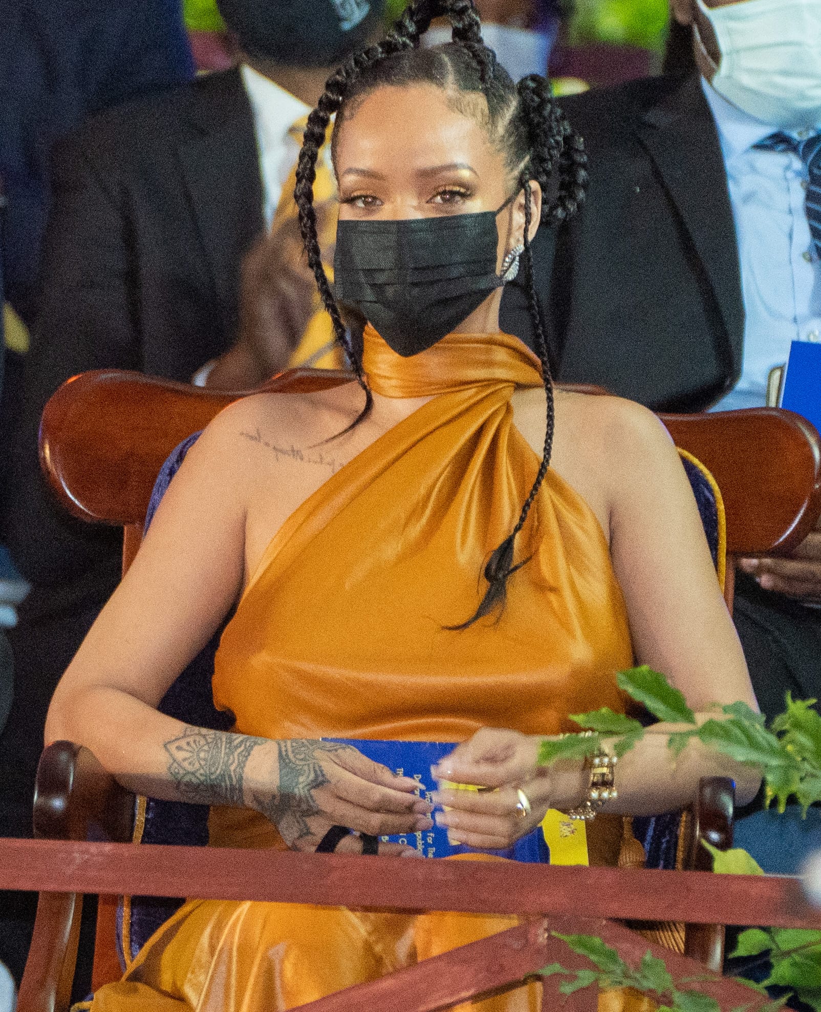 Rihanna wears her hair in braids with minimal makeup accentuating her eyes