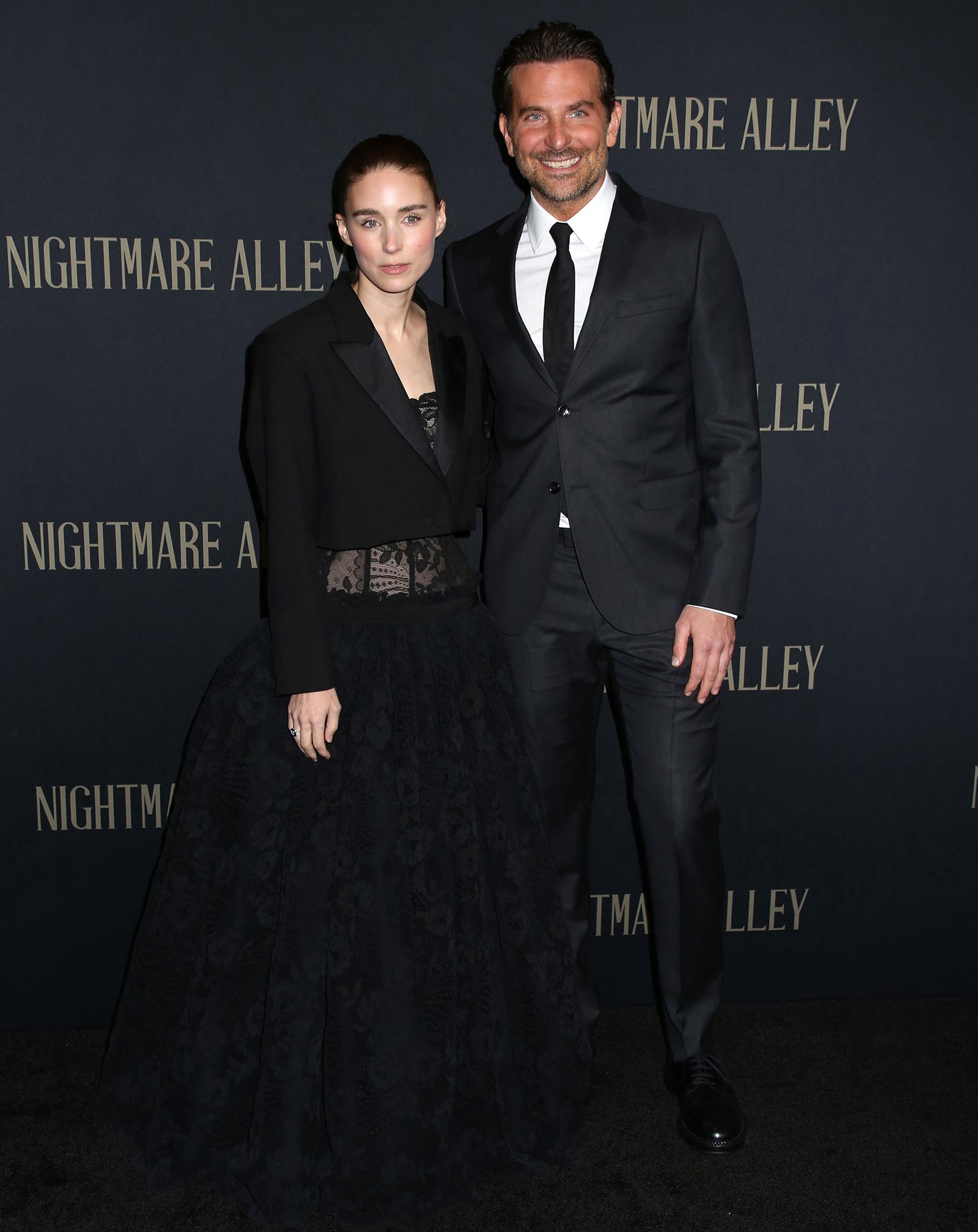 Rooney Mara and Bradley Cooper pose together at the premiere of their movie Nightmare Alley