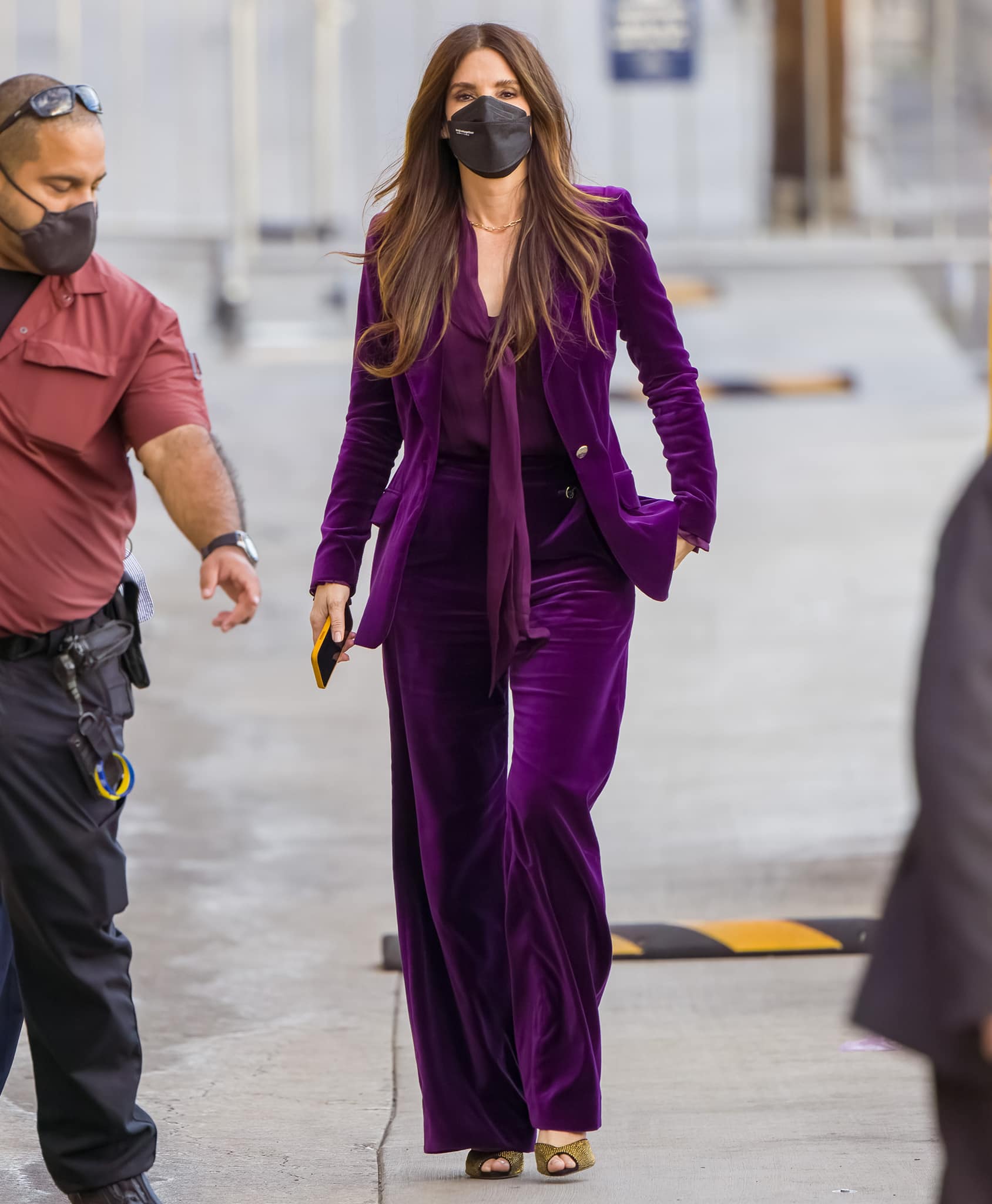Sandra Bullock is elegant in a rich plum Temperley London Fall 2021 pant suit