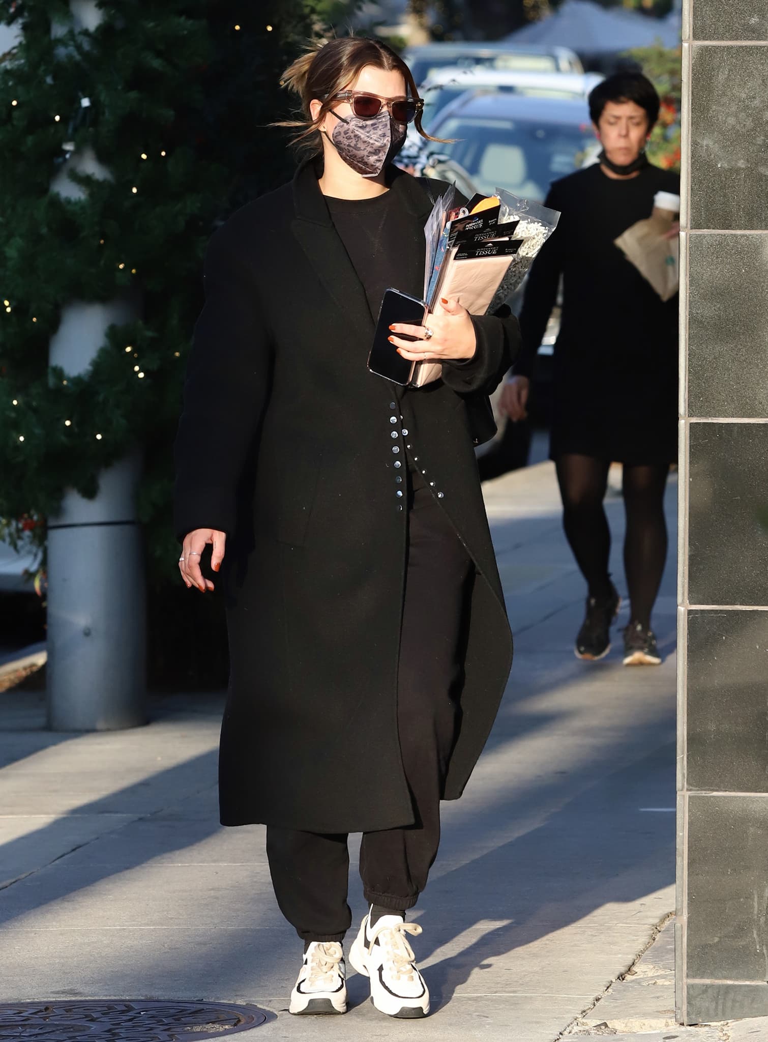 Sofia Richie shows how to elevate comfy sweat pants and sneakers with a trench coat