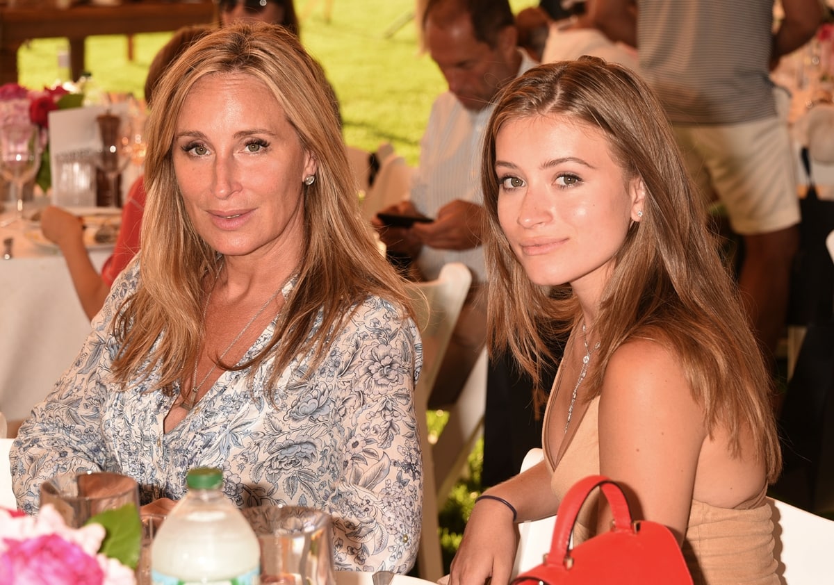 Sonja Morgan and daughter Quincy Morgan pose for photos together while seated at a table
