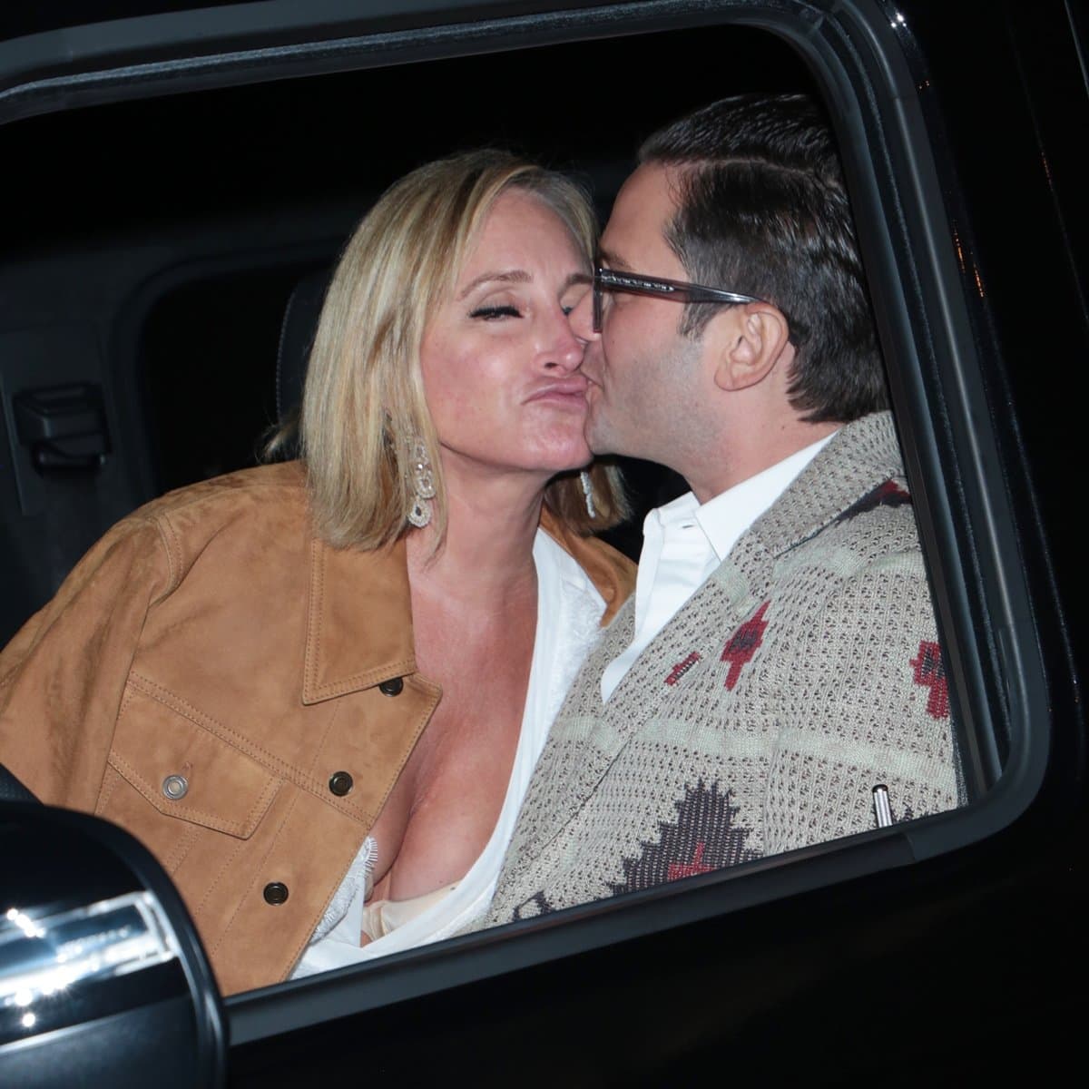 Luxury real estate agent Josh Flagg kisses Sonja Morgan outside Craig's restaurant