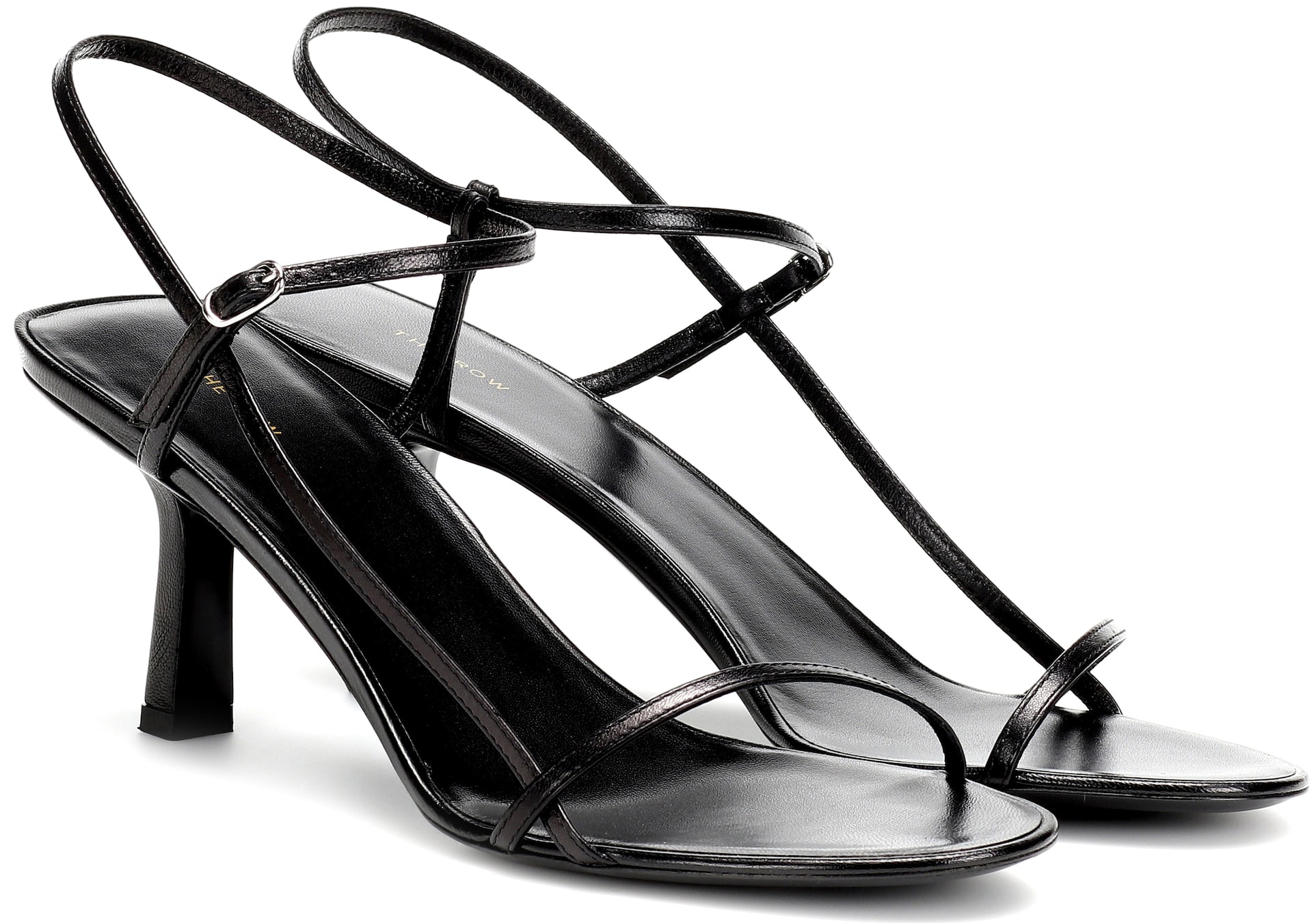 A minimalist pair of sandals that feature barely-there delicate straps and modest heels