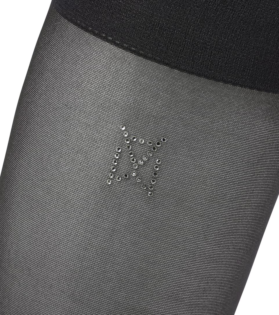 The Wolford x Amina Muaddi socks feature crystal adornments that form the brand's emblem