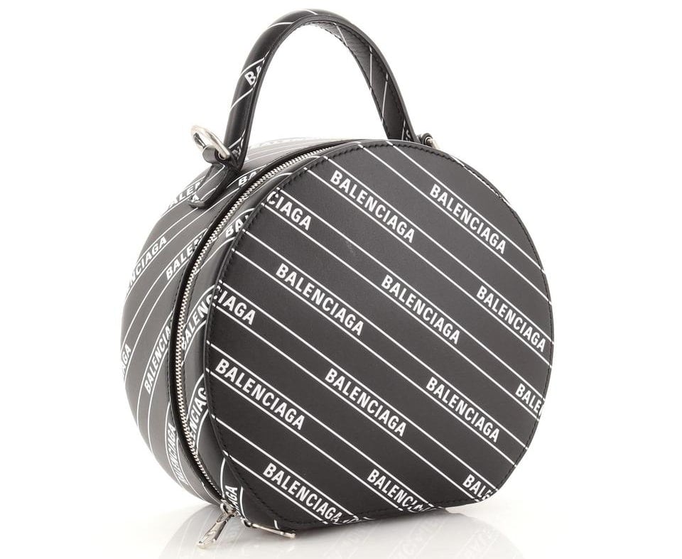 This Vanity XS Round bag is made of logo-print leather and is sized to fit the necessities