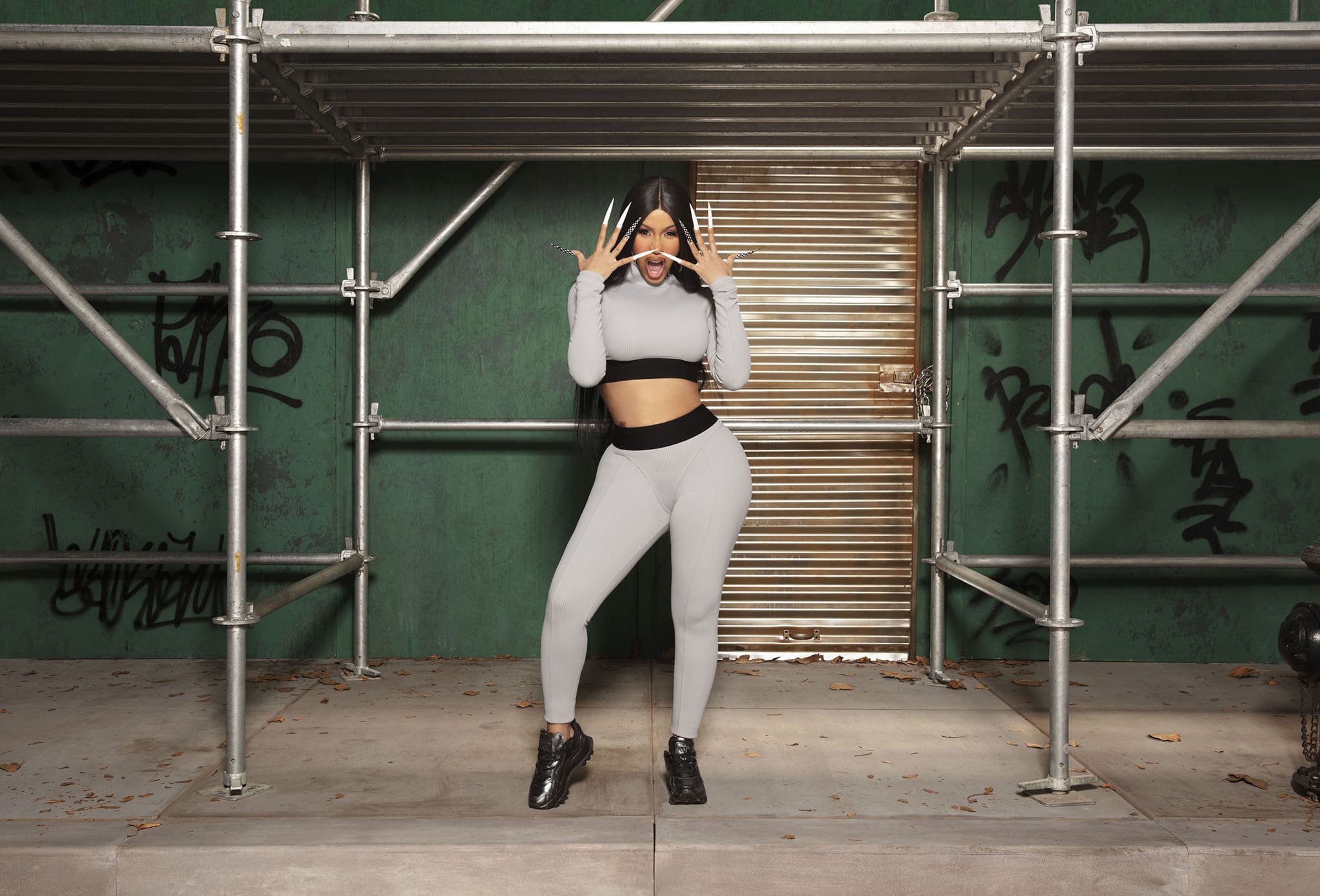 Cardi B shows off her abs in a gray ribbed crop top and matching leggings from the new collection