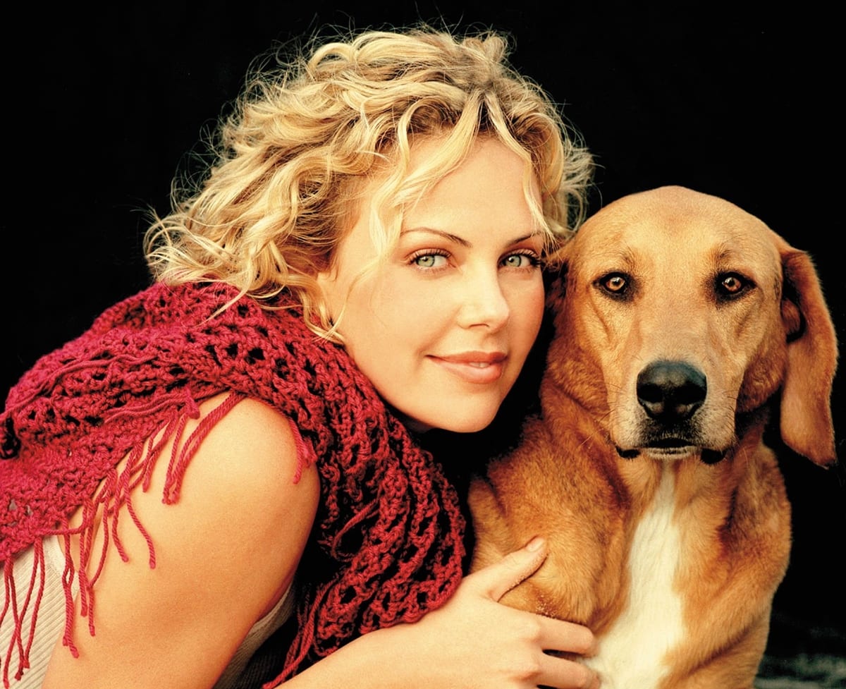 Charlize Theron and her dog, Tucker, pose for the 2003 Purina Dog Chow Incredible Dogs Calendar