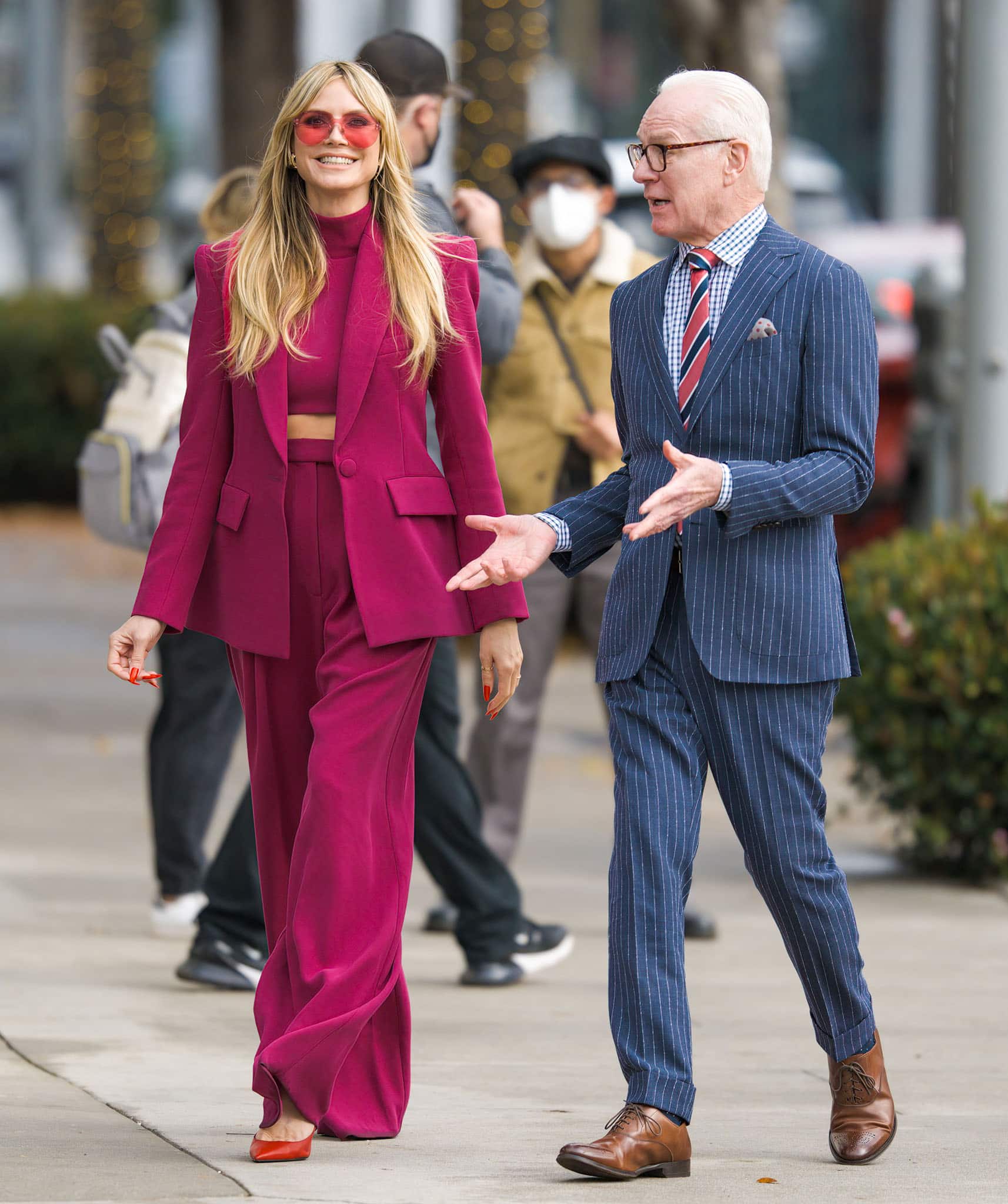 Heidi Klum pairs her pink pantsuit with red nails and red Christian Louboutin pumps