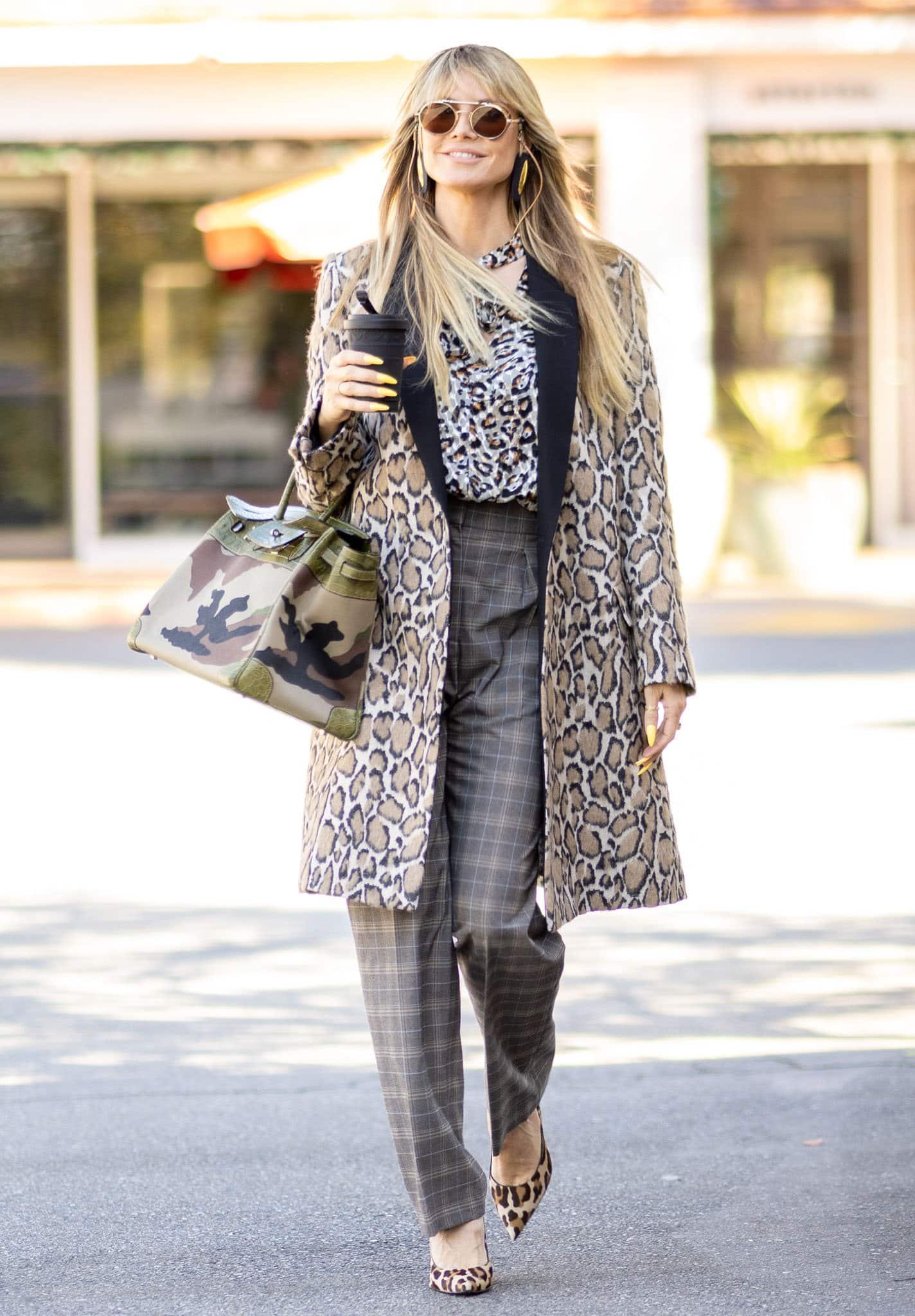 Heidi Klum wearing leopard print blouse, coat, and pumps