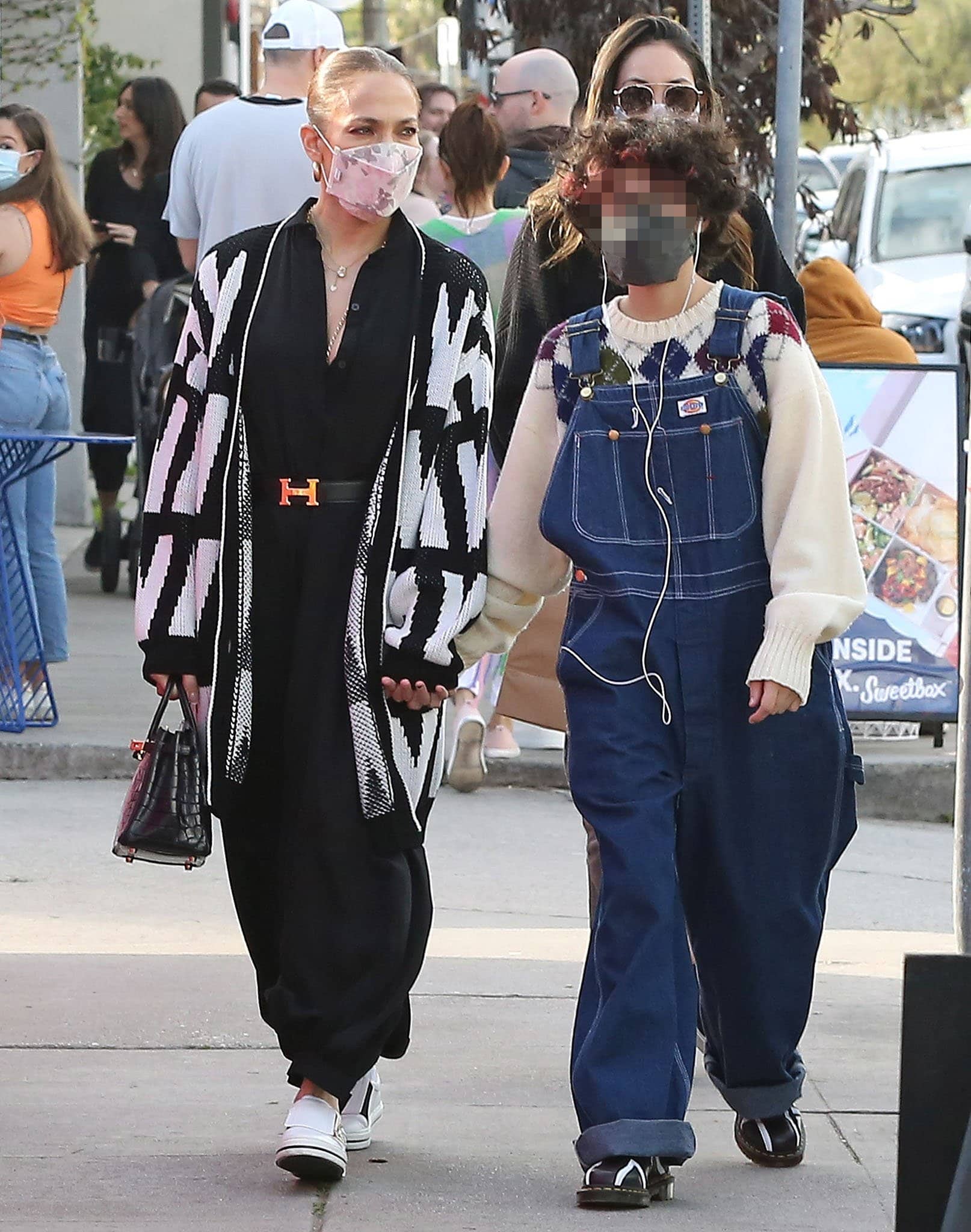 Emme shows off her kooky style in Dickies denim overalls and a cream argyle sweater