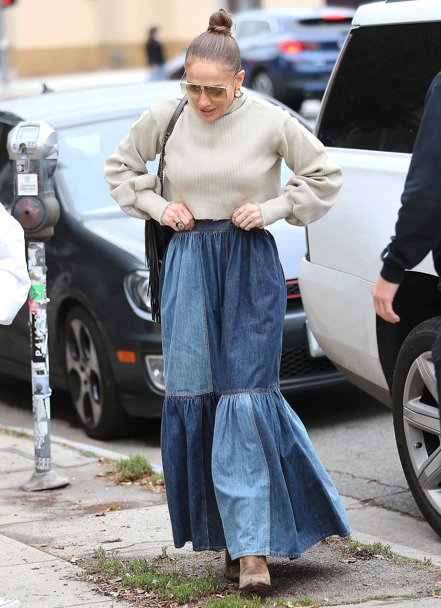 Jennifer Lopez goes Western-Bohemian in Orseund Iris crop sweater and Dior denim maxi skirt