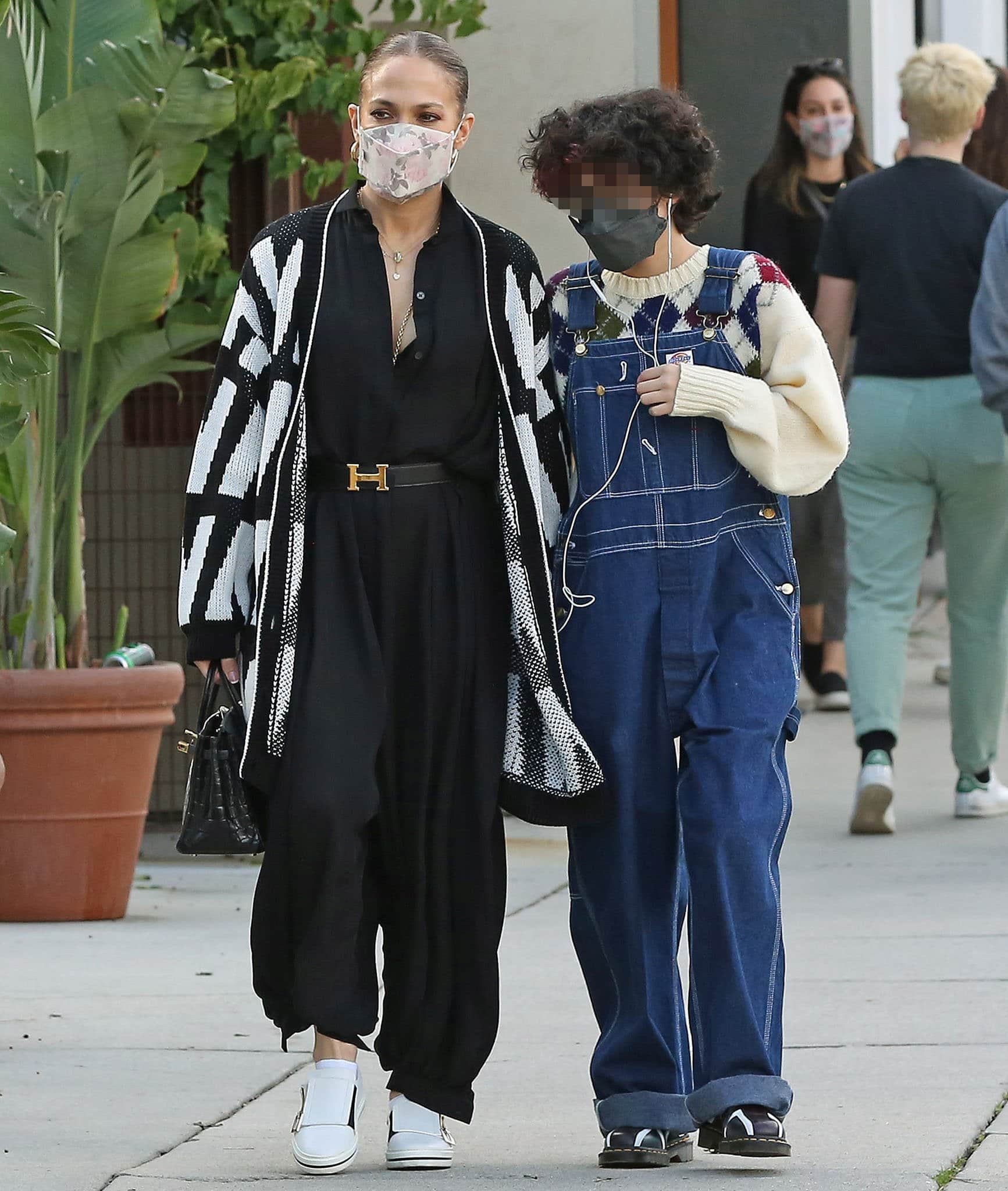 Jennifer Lopez looks classy in her casual flowy black jumpsuit and Valentino cardigan