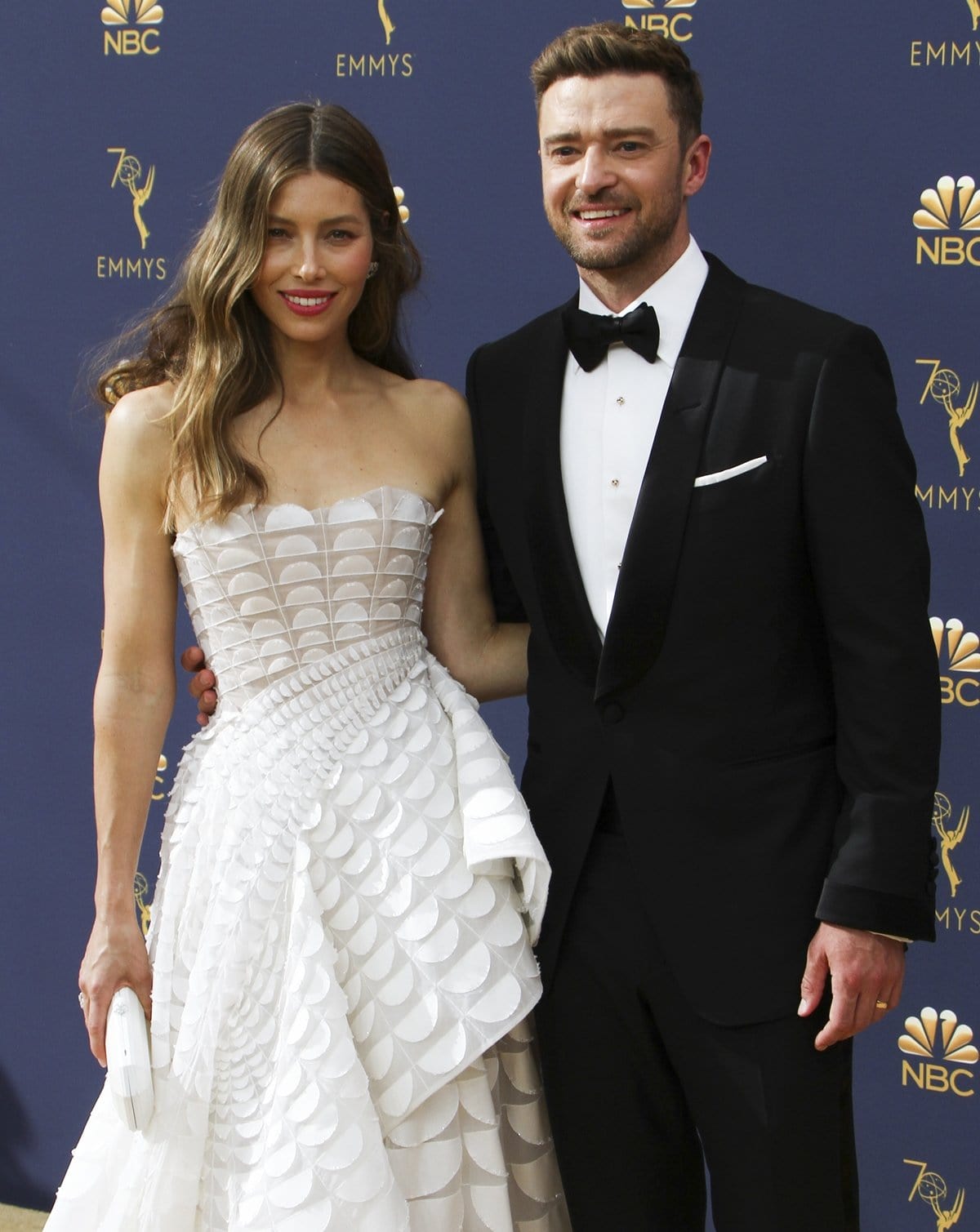 Jessica Biel and Justin Timberlake bring Hollywood glamour to the 70th Primetime Emmy Awards, with Jessica in a stunning white strapless gown and Justin looking sharp in a classic black tuxedo