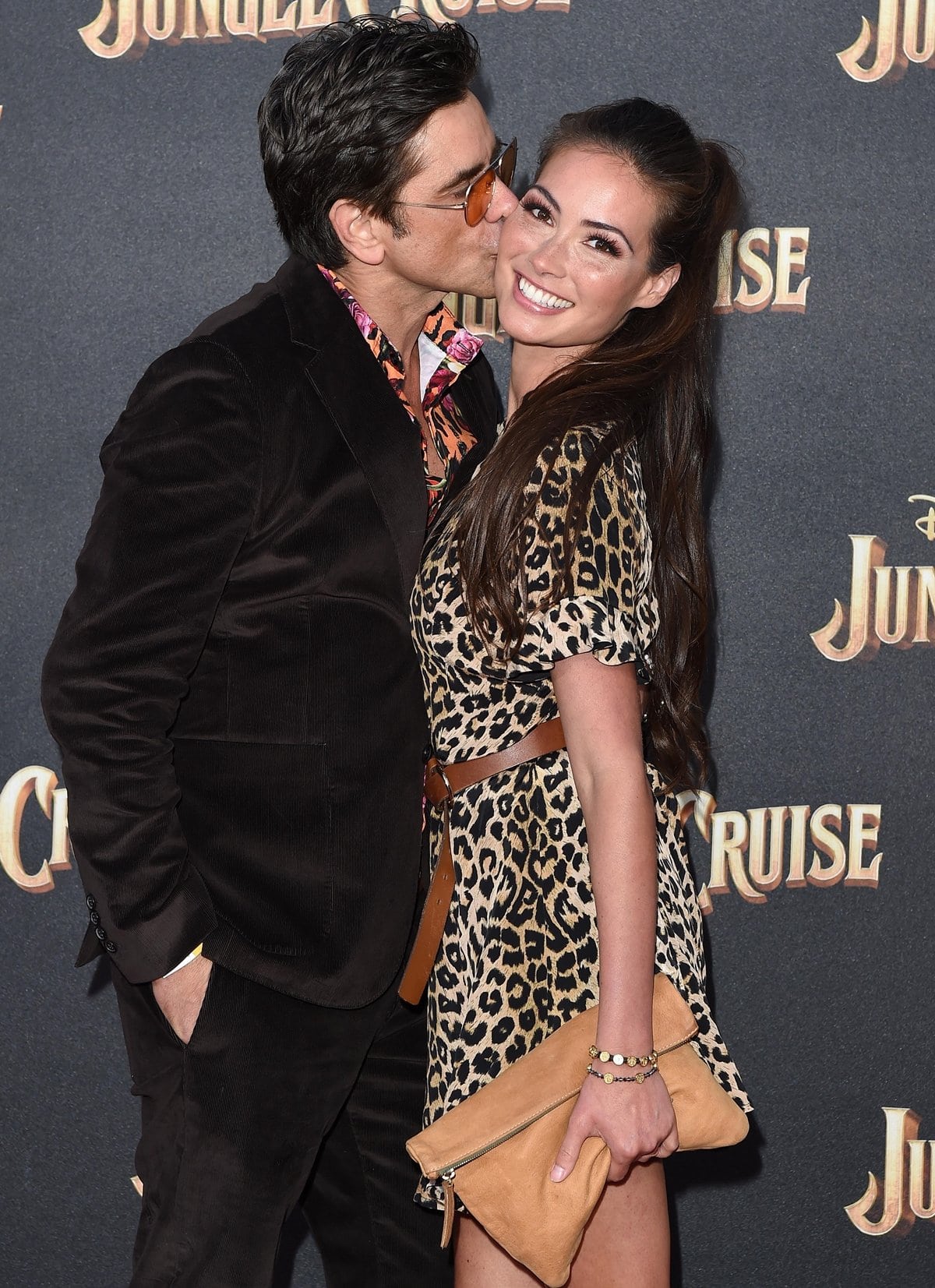 John Stamos kisses his much younger wife Caitlin McHugh at Disney's "Jungle Cruise" Premiere