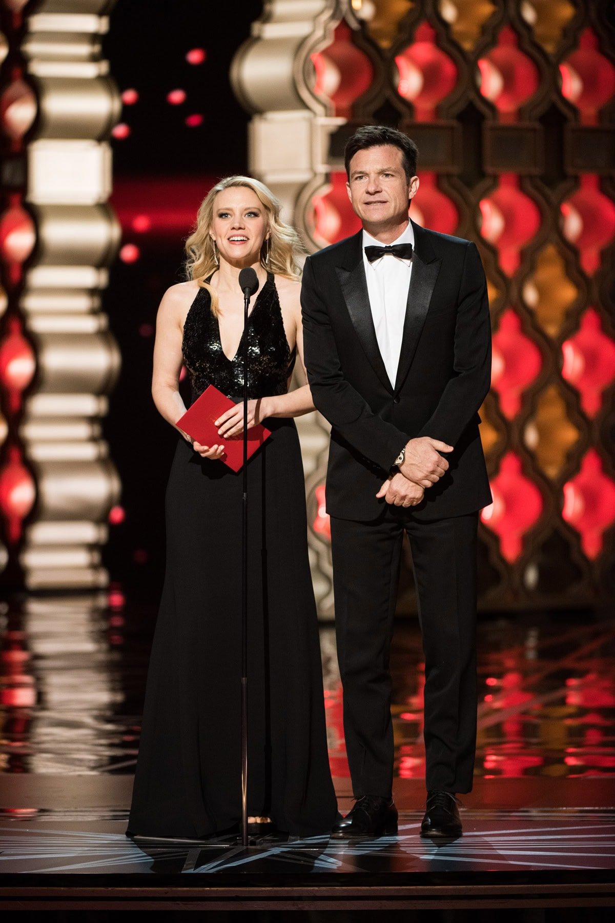 Kate McKinnon and Jason Bateman present the Oscar for Achievement in Makeup at the 89th Academy Awards on February 26, 2017, at the Dolby Theatre in Hollywood — McKinnon wears a Narciso Rodriguez gown, Stuart Weitzman heels, and Chopard jewelry