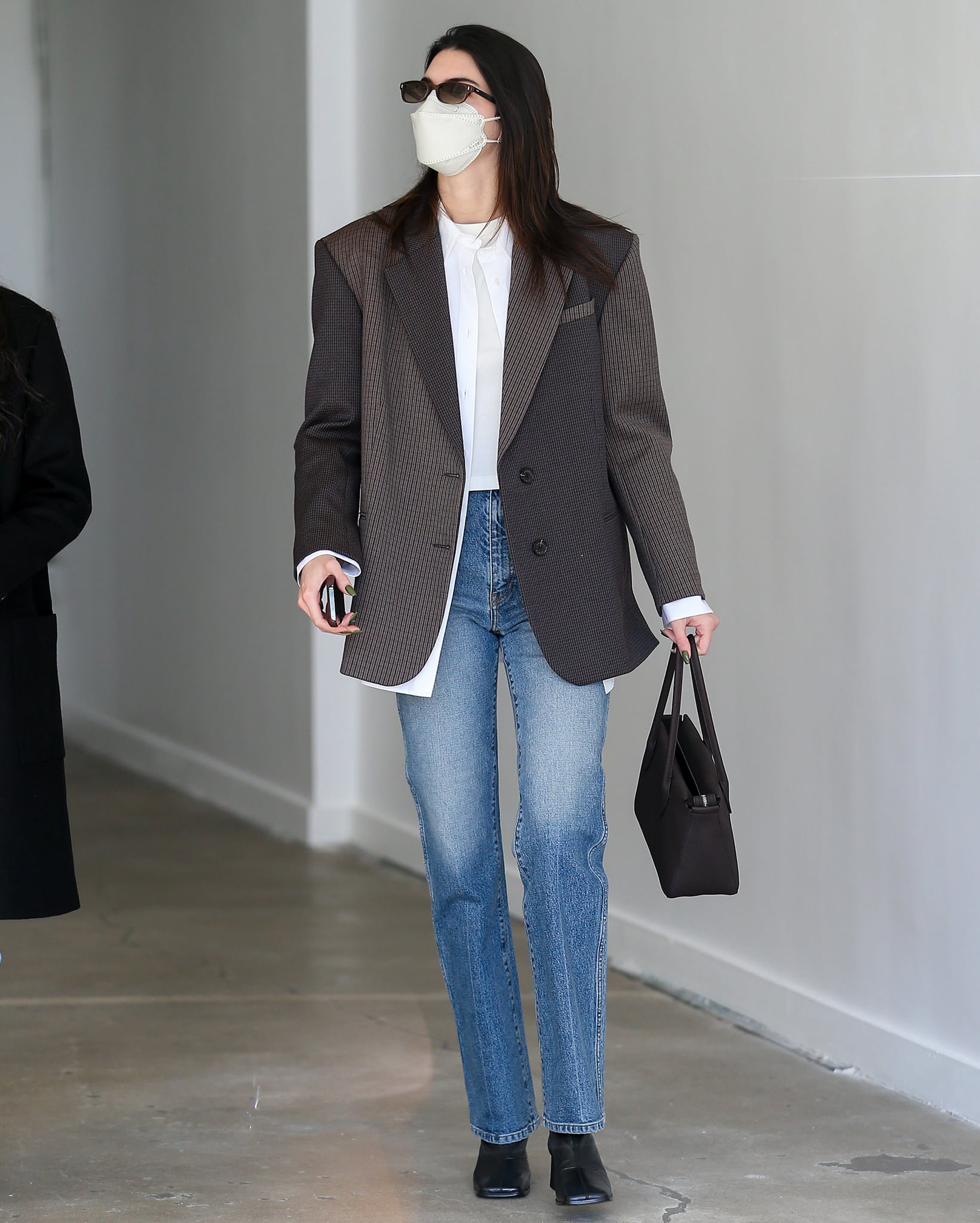 Kendall Jenner opts for business-casual in Sandro brown blazer, white shirt, and Khaite jeans