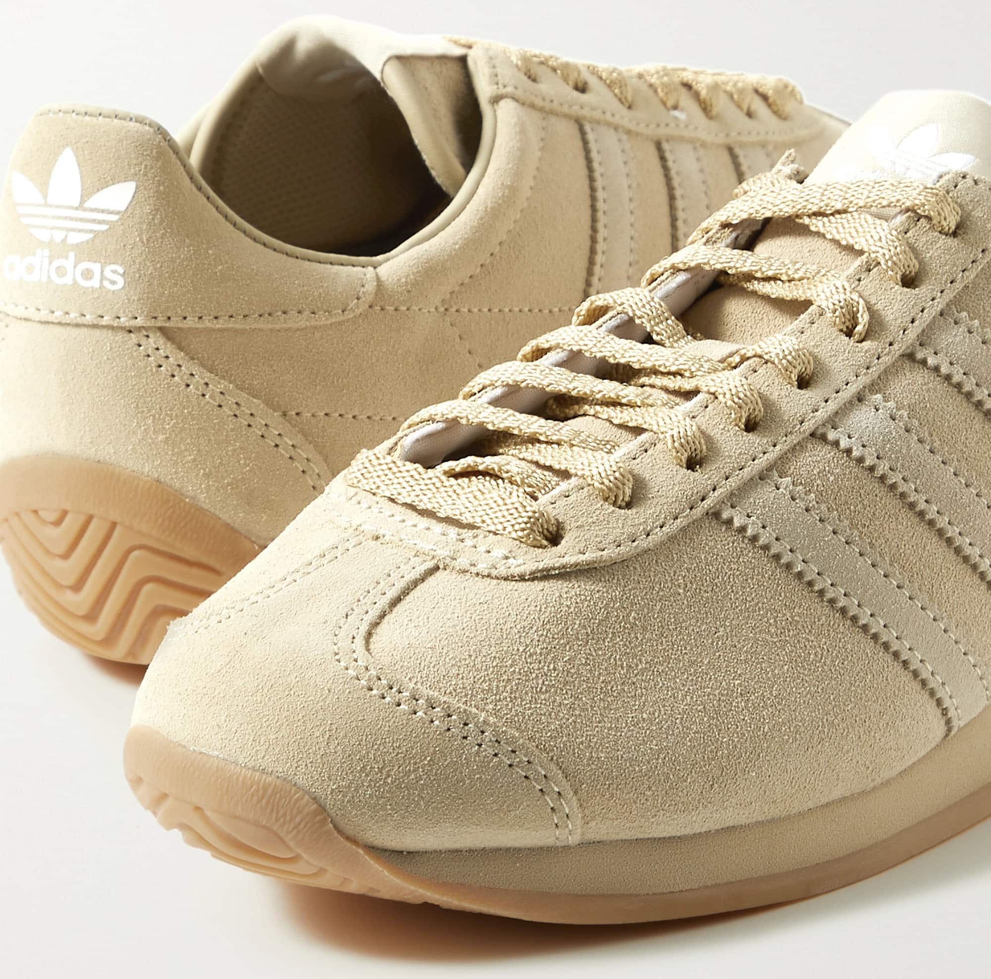 This Khaite x Adidas collaboration features the sports giant's classic running style done in ecru suede material