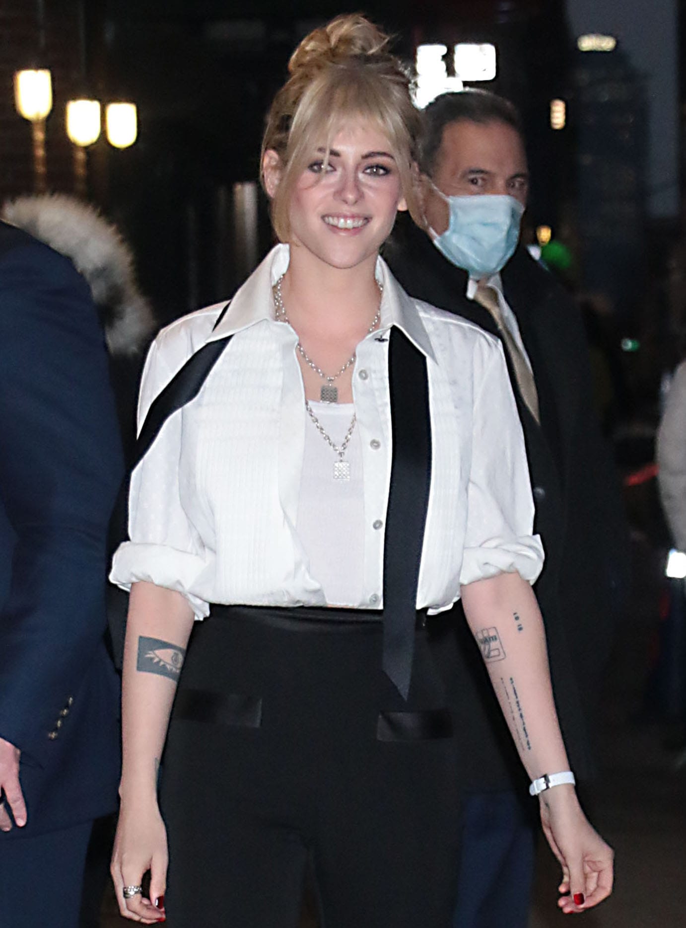 Kristen Stewart styles her hair in a messy updo and wears kohl-rimmed eyes with nude lipstick
