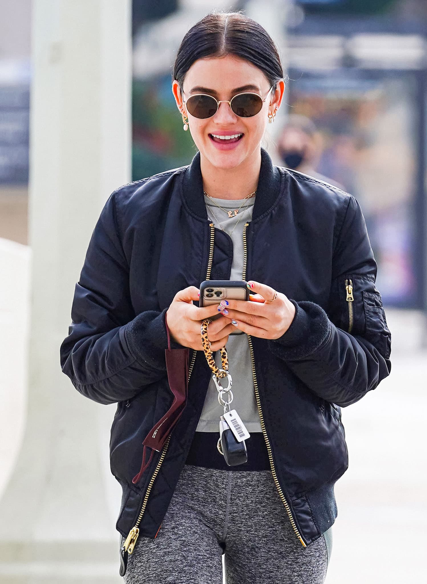 Lucy Hale flashes her pearly whites as she styles her athleisure with gold jewelry