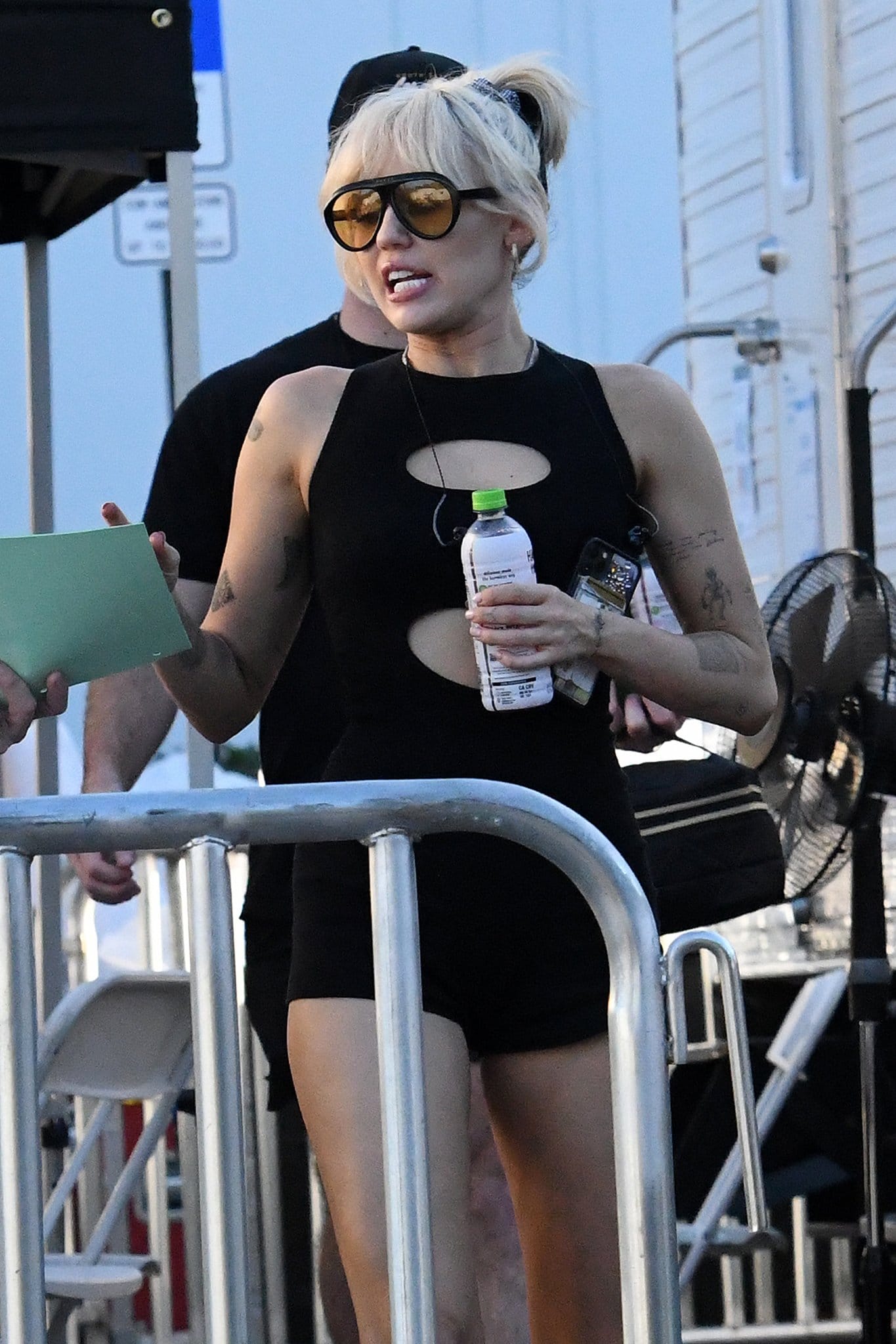 Miley Cyrus pulls her blonde tresses up and hides her eyes behind a pair of Gucci Navigator sunnies