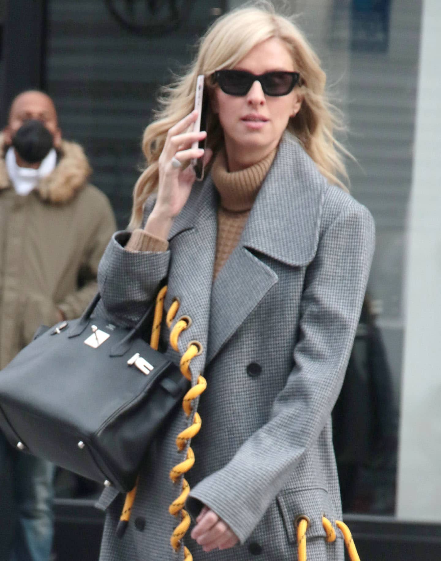 Nicky Hilton wears her blonde hair down and shields her eyes behind black sunnies