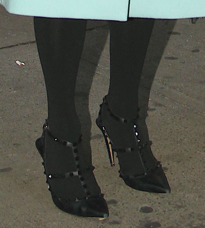 Paris Hilton teams her mint-colored coat with Valentino Rockstud pumps
