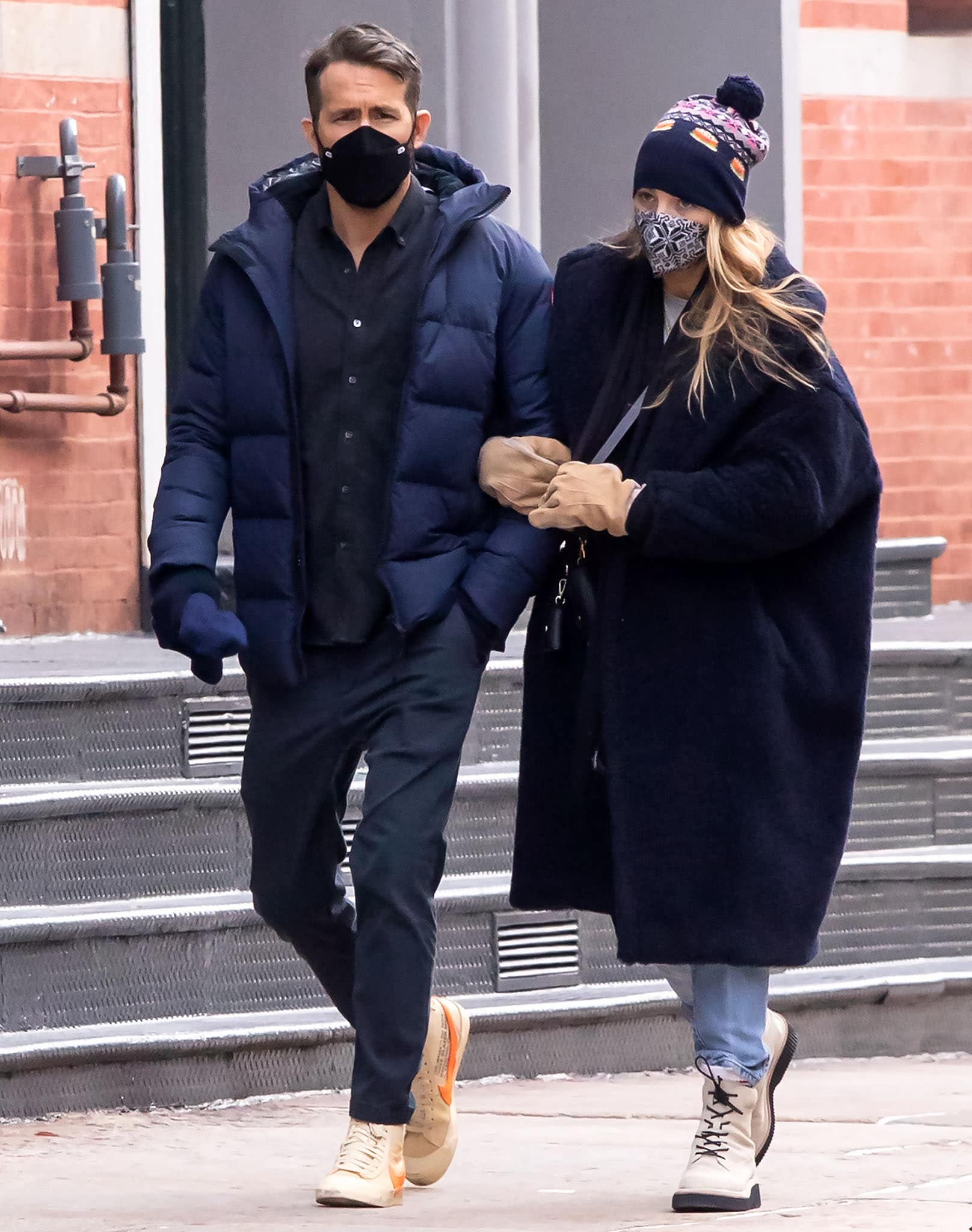 Ryan Reynolds stays warm in a navy Canada Goose puffer jacket, jeans, and Off-White x Nike Blazer sneakers