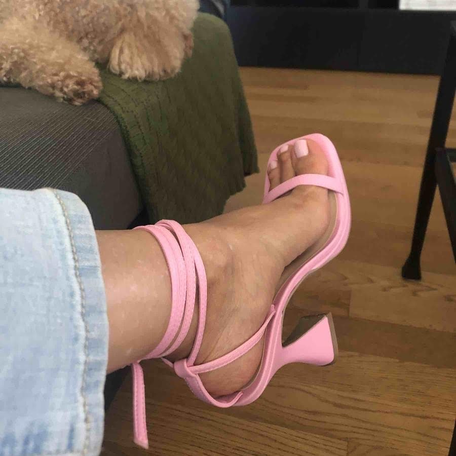 This square-toe pink sandal topped with wraparound ankle straps is raised on a tall, sculptural heel that brings individuality to your ensembles