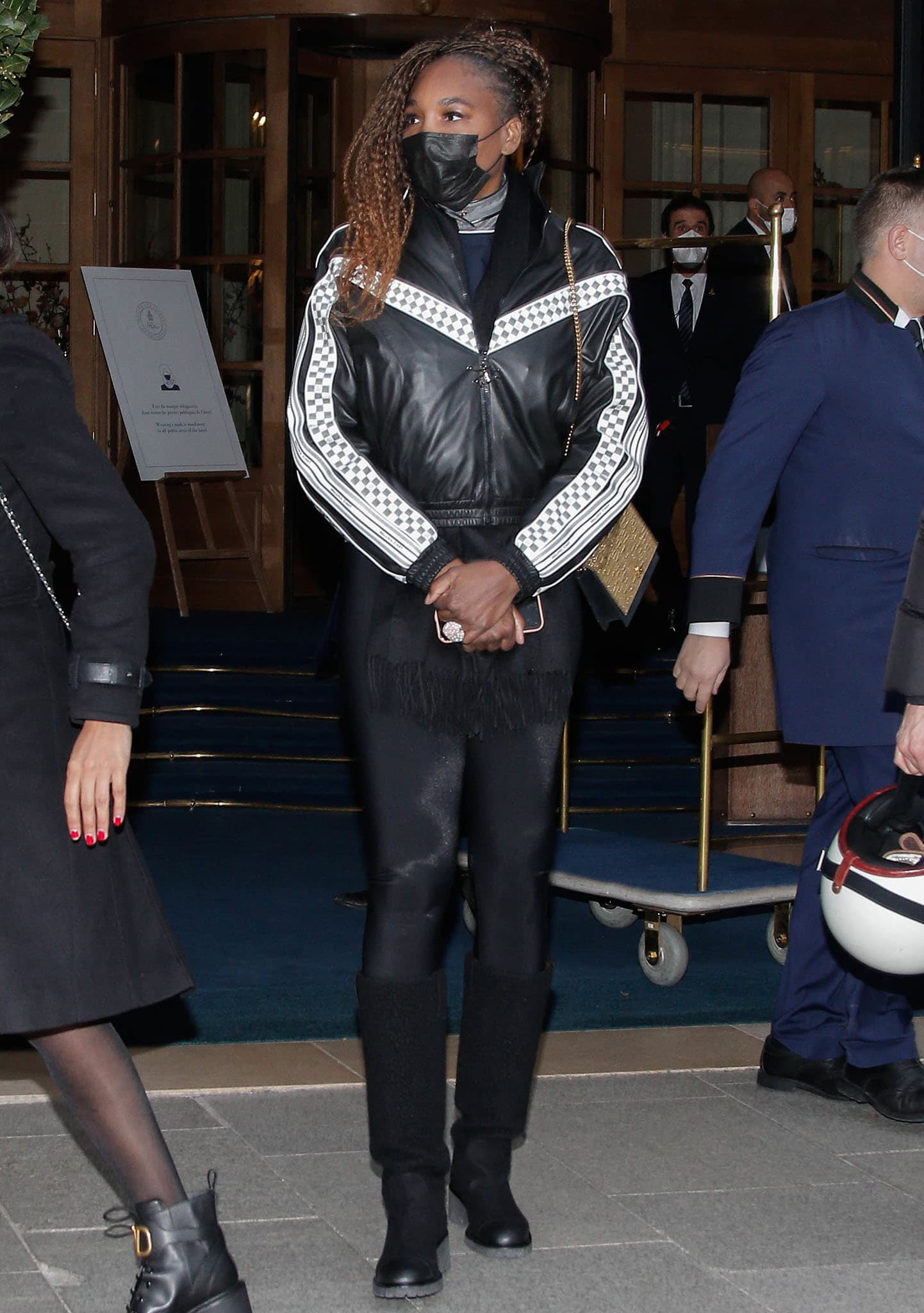 Venus Williams steps out of her Paris hotel in a cozy Louis Vuitton bomber jacket, leggings, and a winter scarf