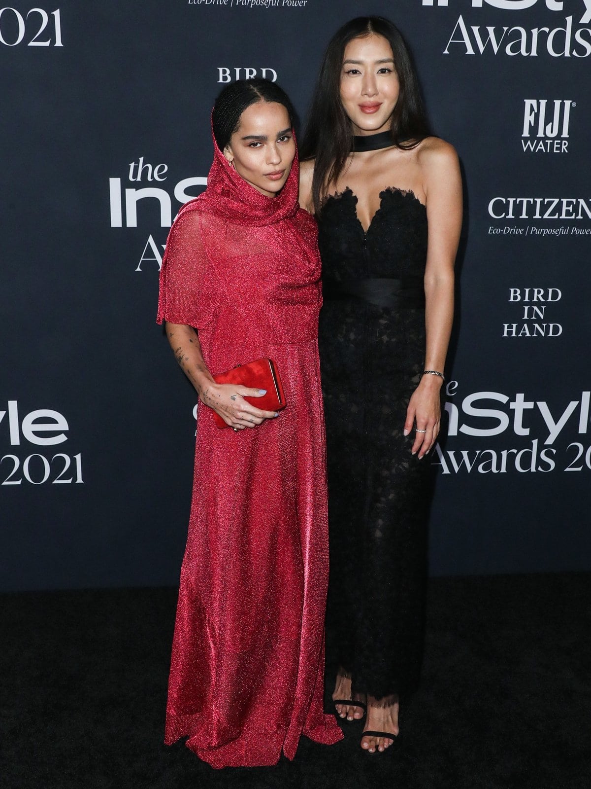 Actress Zoë Isabella Kravitz in a red hooded gown with much taller make-up artist Nina Park