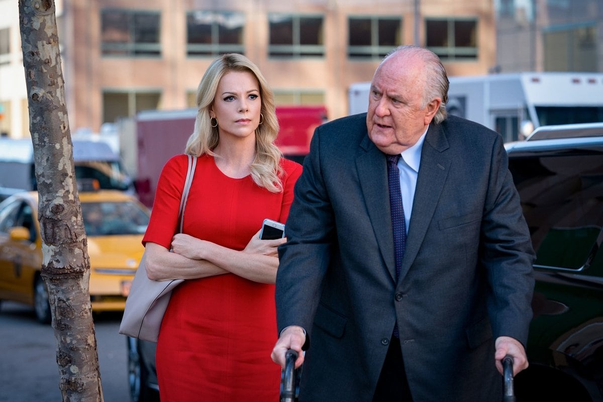 Charlize Theron as Megyn Kelly and John Lithgow as Roger Ailes in the 2019 drama film Bombshell