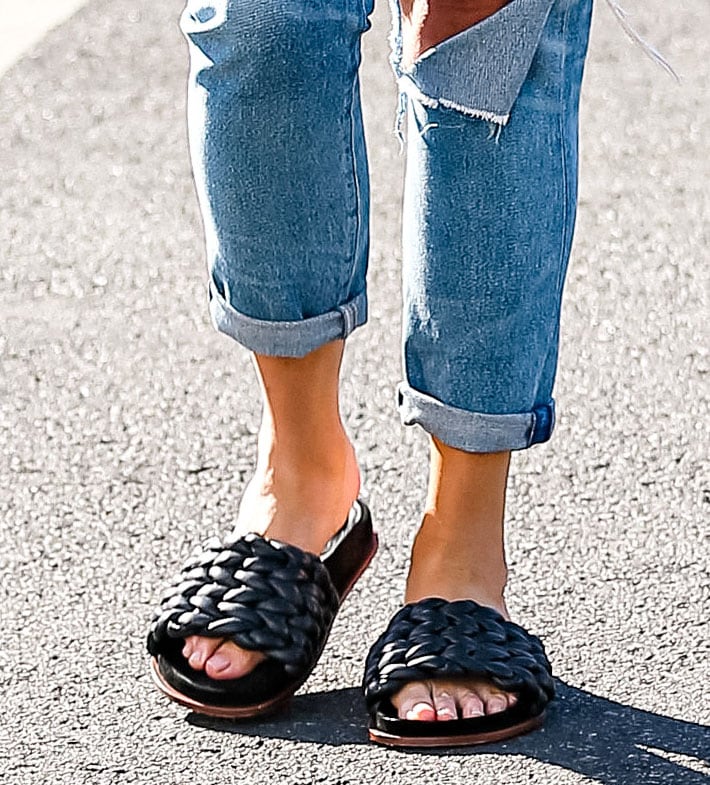 Chrissy Teigen shows her toes in Chloe Kacey braided leather slide sandals