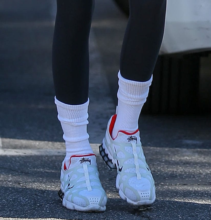 Kendall completes her Pilates outfit with the Stussy x Nike Air Zoom Spiridon white sneakers