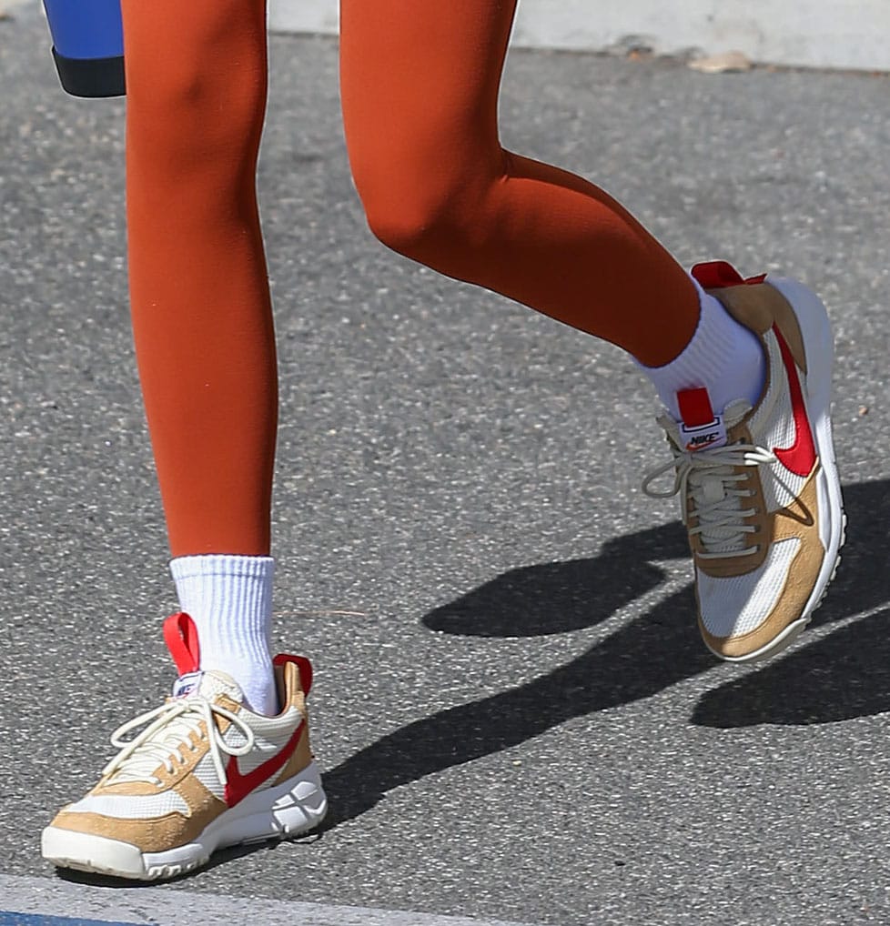 Kendall Jenner pairs her orange sports bra and leggings with Tom Sachs x NikeCraft Mars Yard sneakers