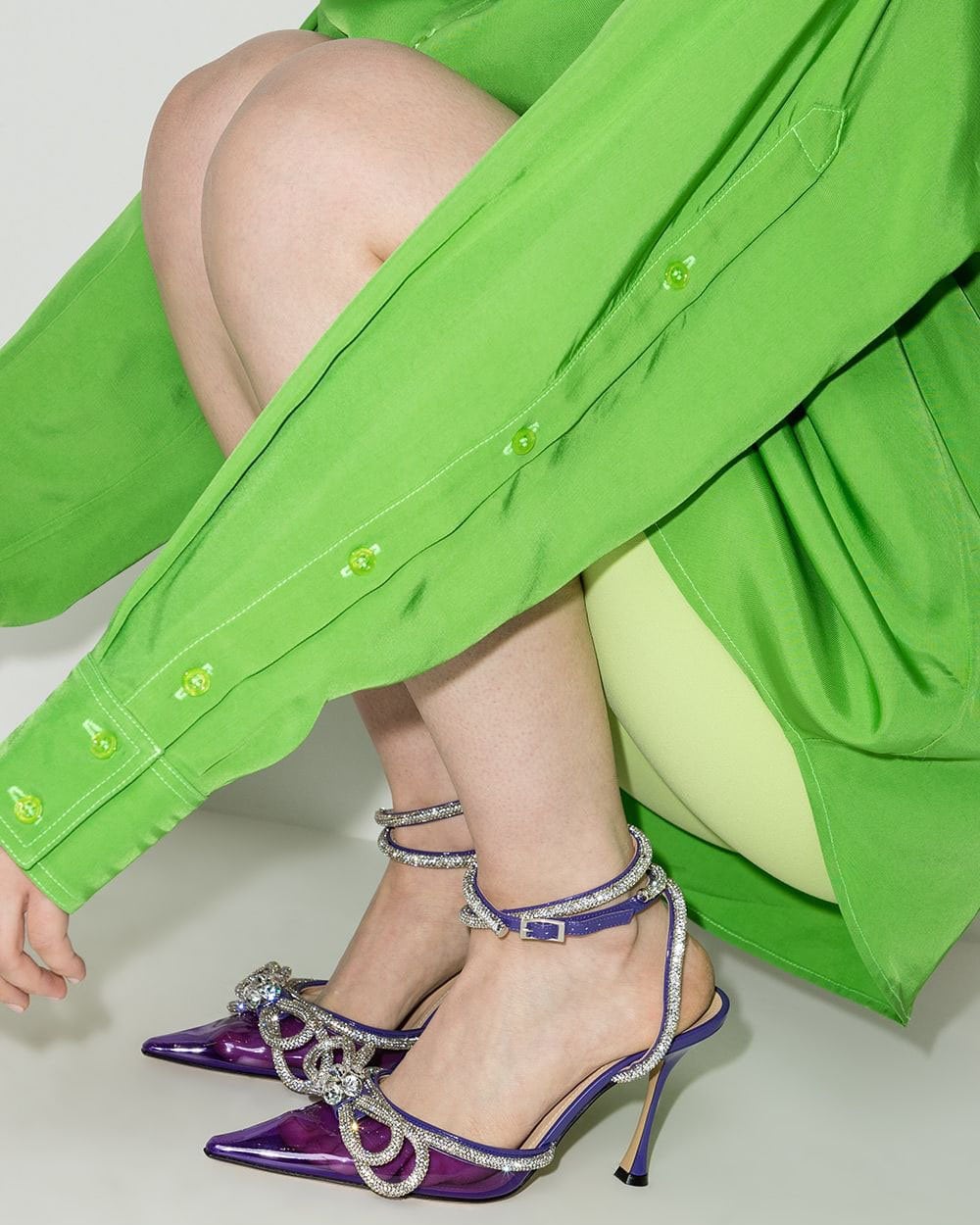 Playful and feminine, the Mach & Mach Double Bow pump is crafted from purple PVC with leather trims and features a crystal-embellished ankle strap and a double bow applique