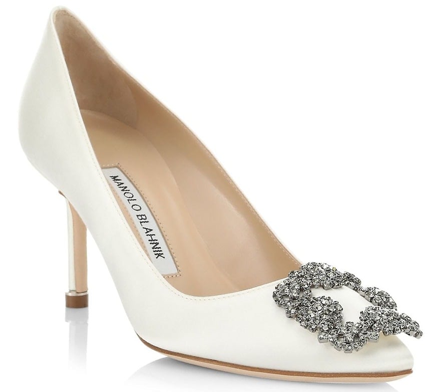 A regal-looking pair, the Hangisi 70 pumps in white satin are crowned with the fashion designer's signature bejeweled square buckle