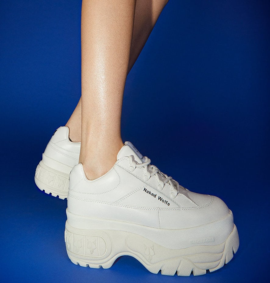 Naked Wolfe's Sporty White sneakers feature a chunky silhouette with rubber Wolfe head plaque and side branding