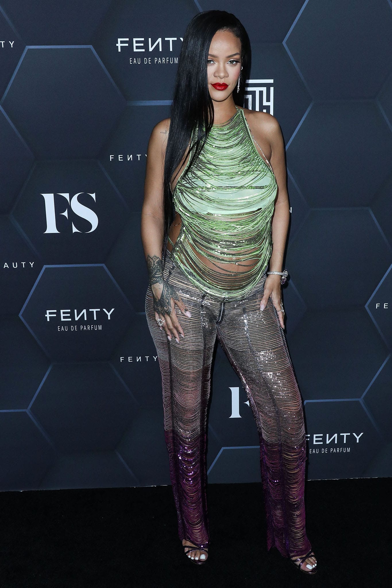 Rihanna shows off her baby bump in The Attico green shredded sequin top and purple ombre pants