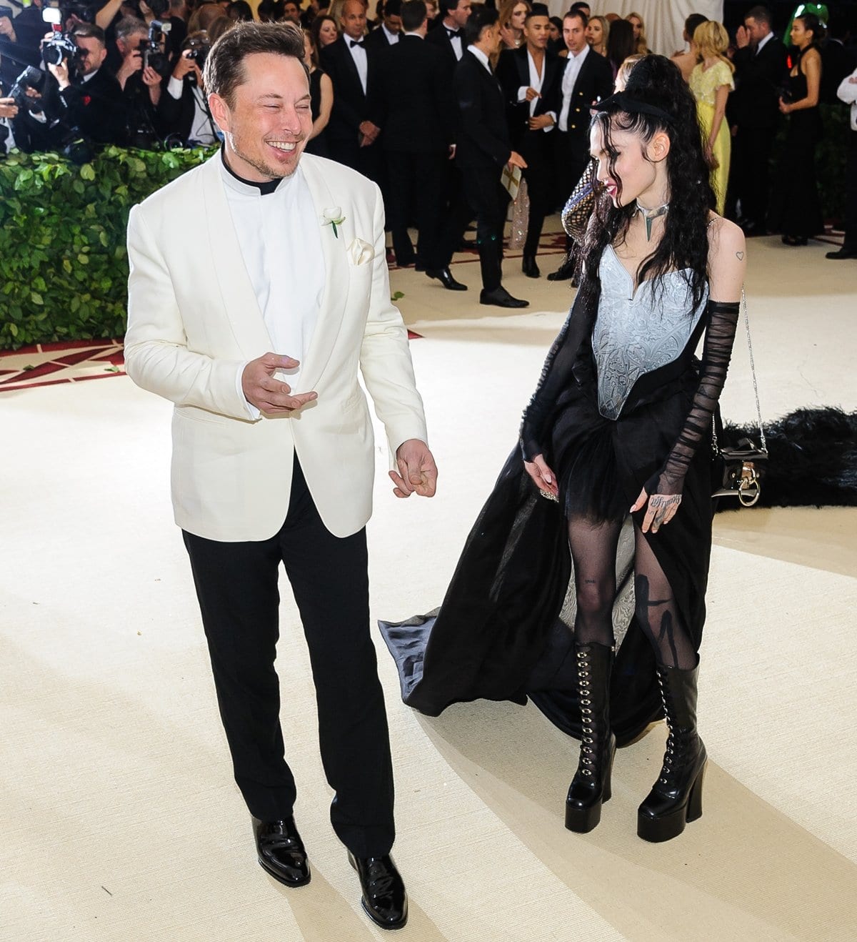 Elon Musk and Grimes wearing a Tesla choker made their red carpet debut together as a couple at the 2018 Metropolitan Museum of Art Costume Institute Benefit Gala
