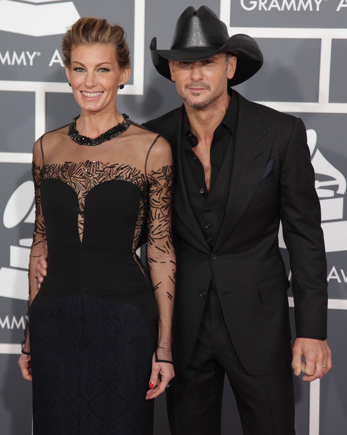 Faith Hill in a black in J. Mendel Pre-Fall 2013 cocktail dress and her husband Tim McGraw arrive at the 55th Annual Grammy Awards