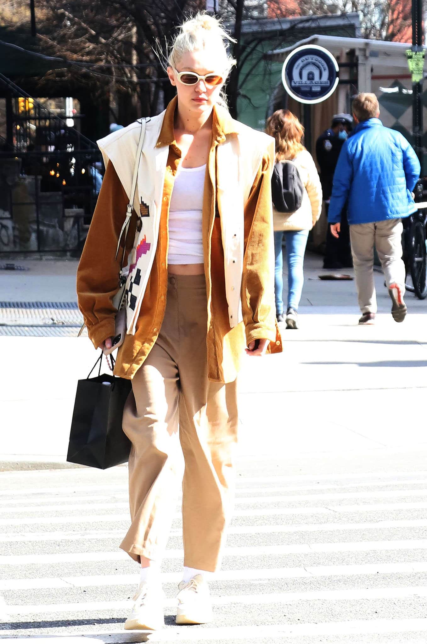 Gigi Hadid with bleached eyebrows and platinum blonde hair color goes shopping in Soho