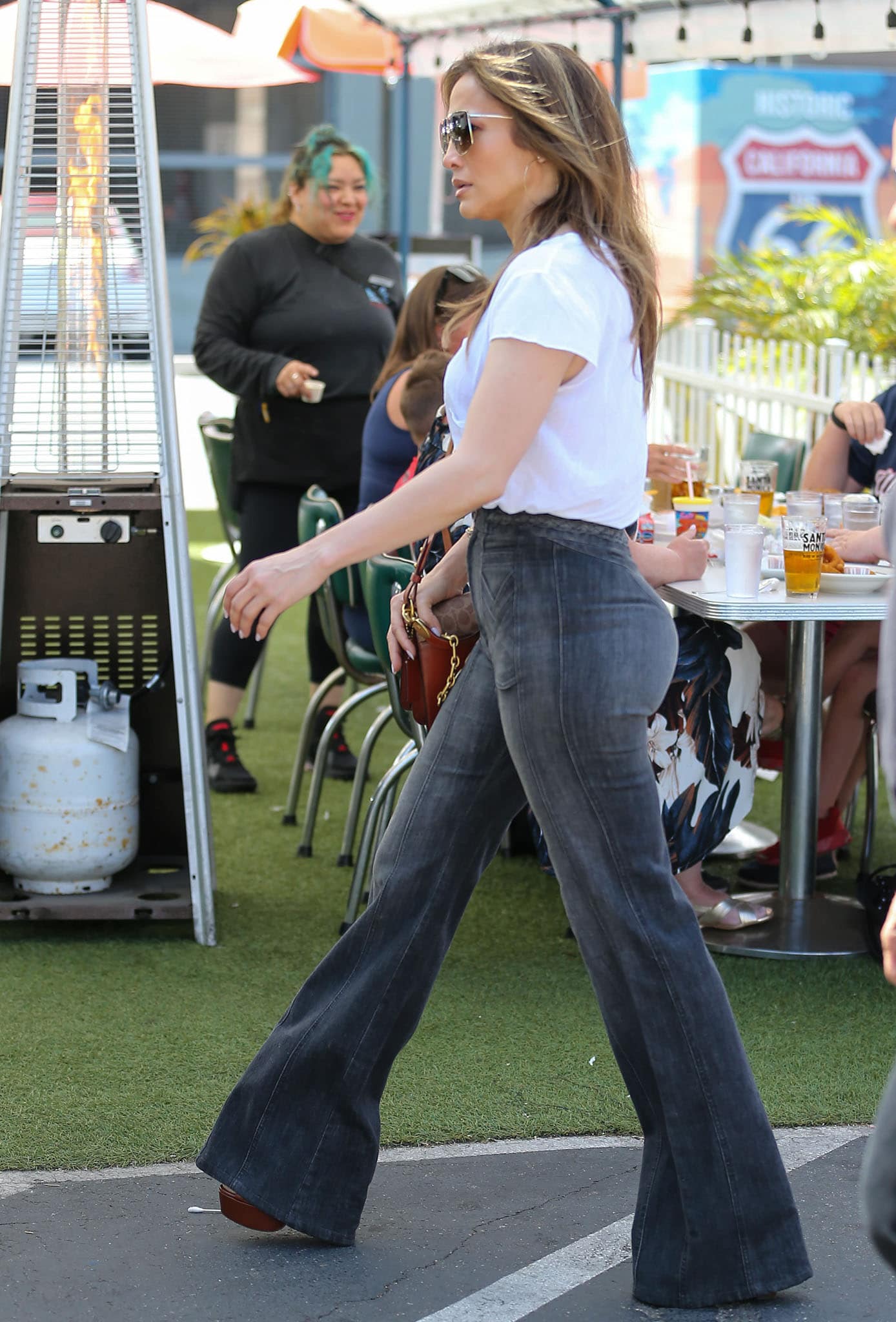 Jennifer Lopez highlights her insured butt in dark-washed flared jeans paired with platform sandals