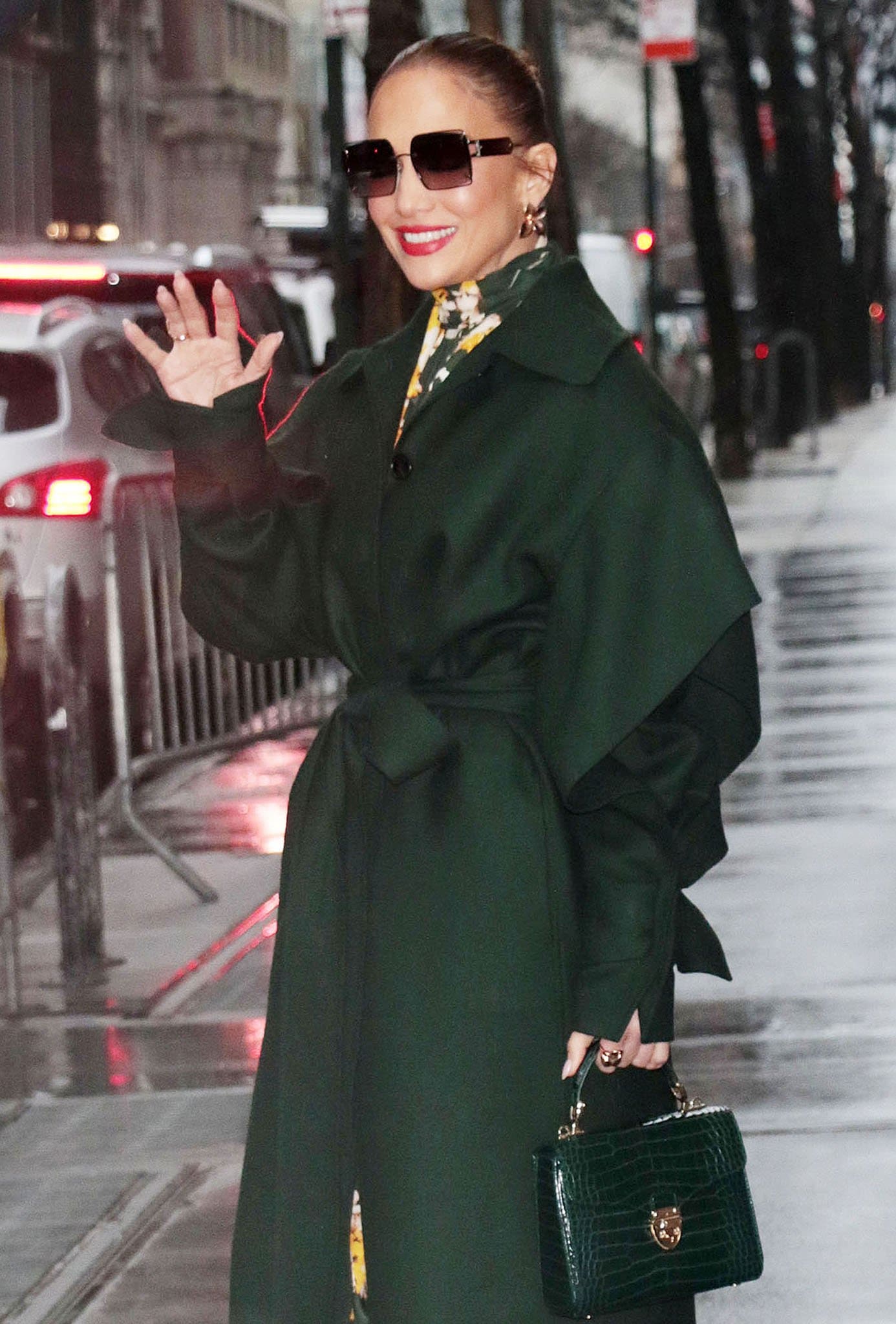 Jennifer Lopez pulls her tresses into a sleek bun and carries a green croc Aspinal Midi Mayfair bag