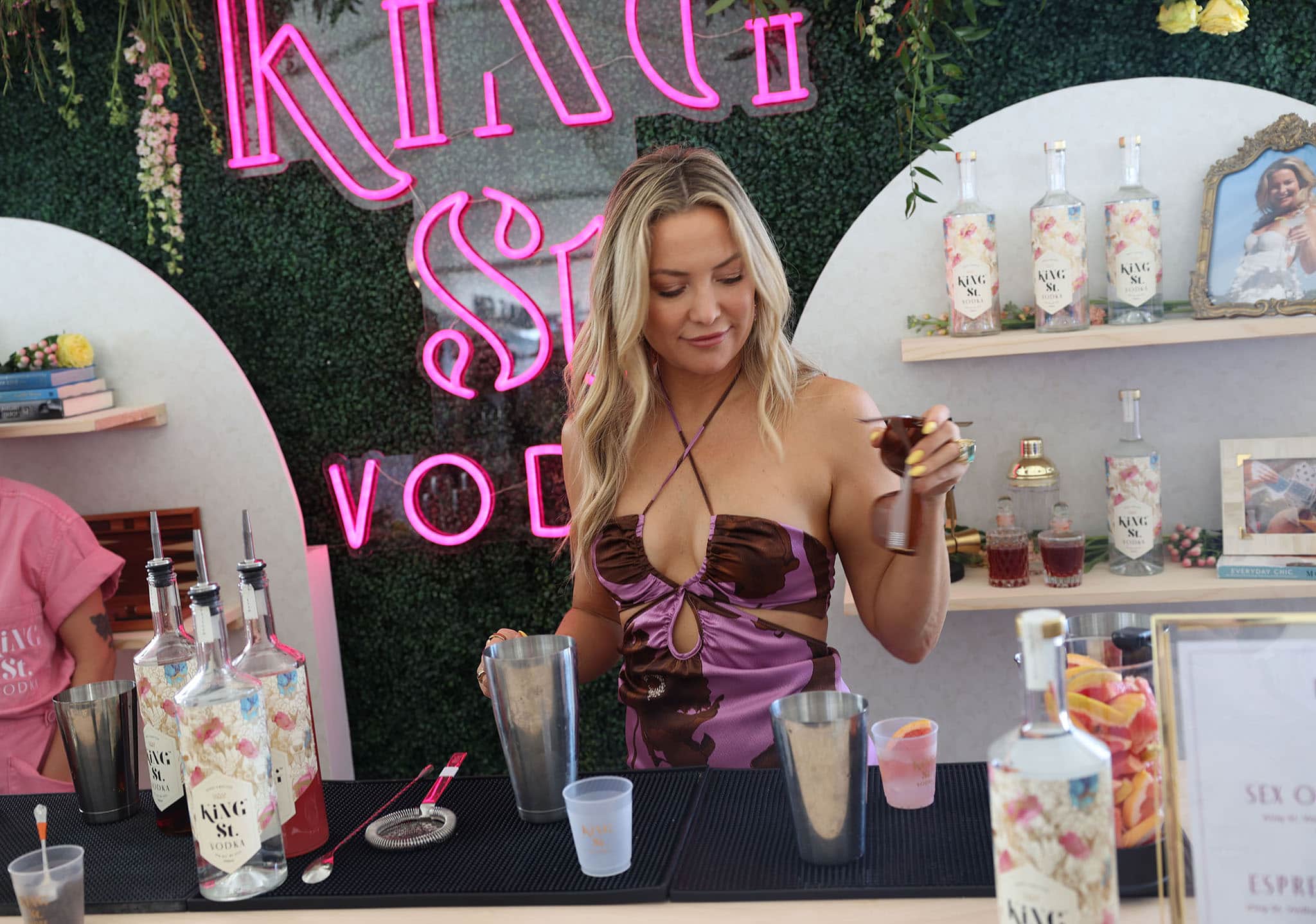 Kate Hudson flaunts her boobs while mixing cocktails in Johanna Ortiz floral halter dress