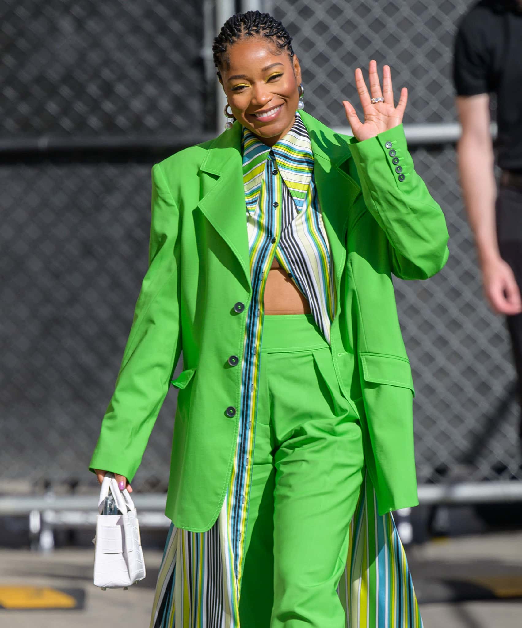 Keke Palmer styles her tresses into a tight dreadlock ponytail and wears coordinating green eyeshadow